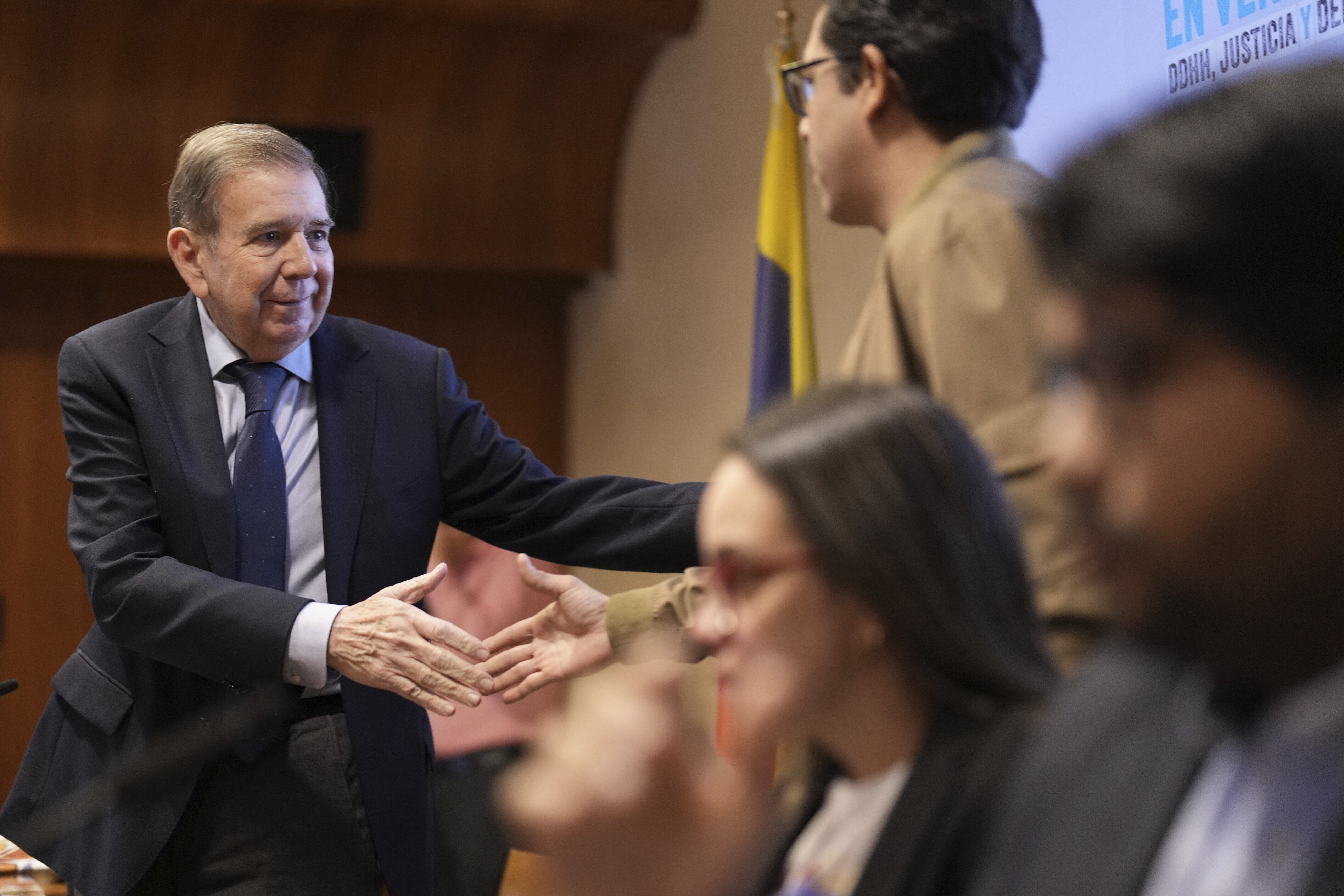 Venezuelan opposition leader Edmundo González shakes hands with relatives of political dissidents to Maduro's regime, during a press conference in downtown Madrid, Spain, Tuesday, Dec. 10, 2024. (AP Photo/Bernat Armangue)