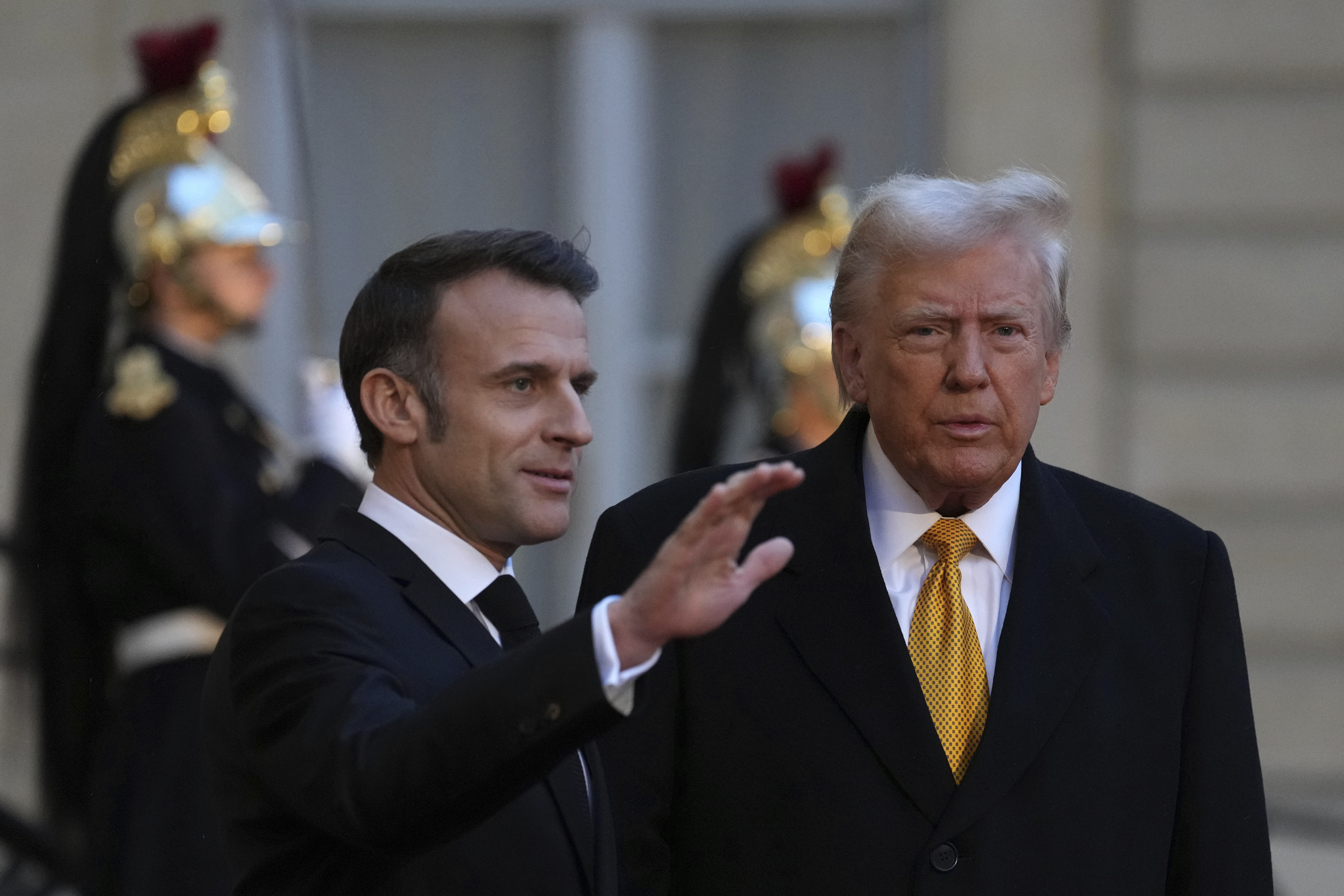 French President Emmanuel Macron, left, welcomes President-elect Donald Trump as he arrives at the Elysee Palace, Saturday, Dec. 7, 2024 in Paris. (AP Photo/Aurelien Morissard)