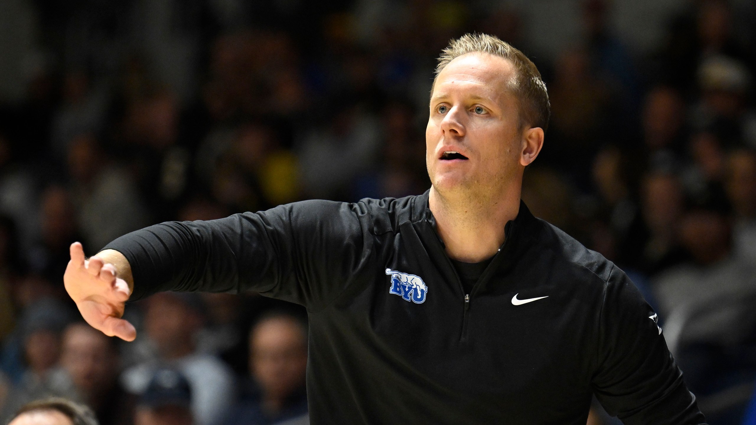 BYU head coach Kevin Young gestures from the sideline during the first half of an NCAA college basketball game against North Carolina State, Friday, Nov. 29, 2024, in San Diego. (AP Photo/Denis Poroy)