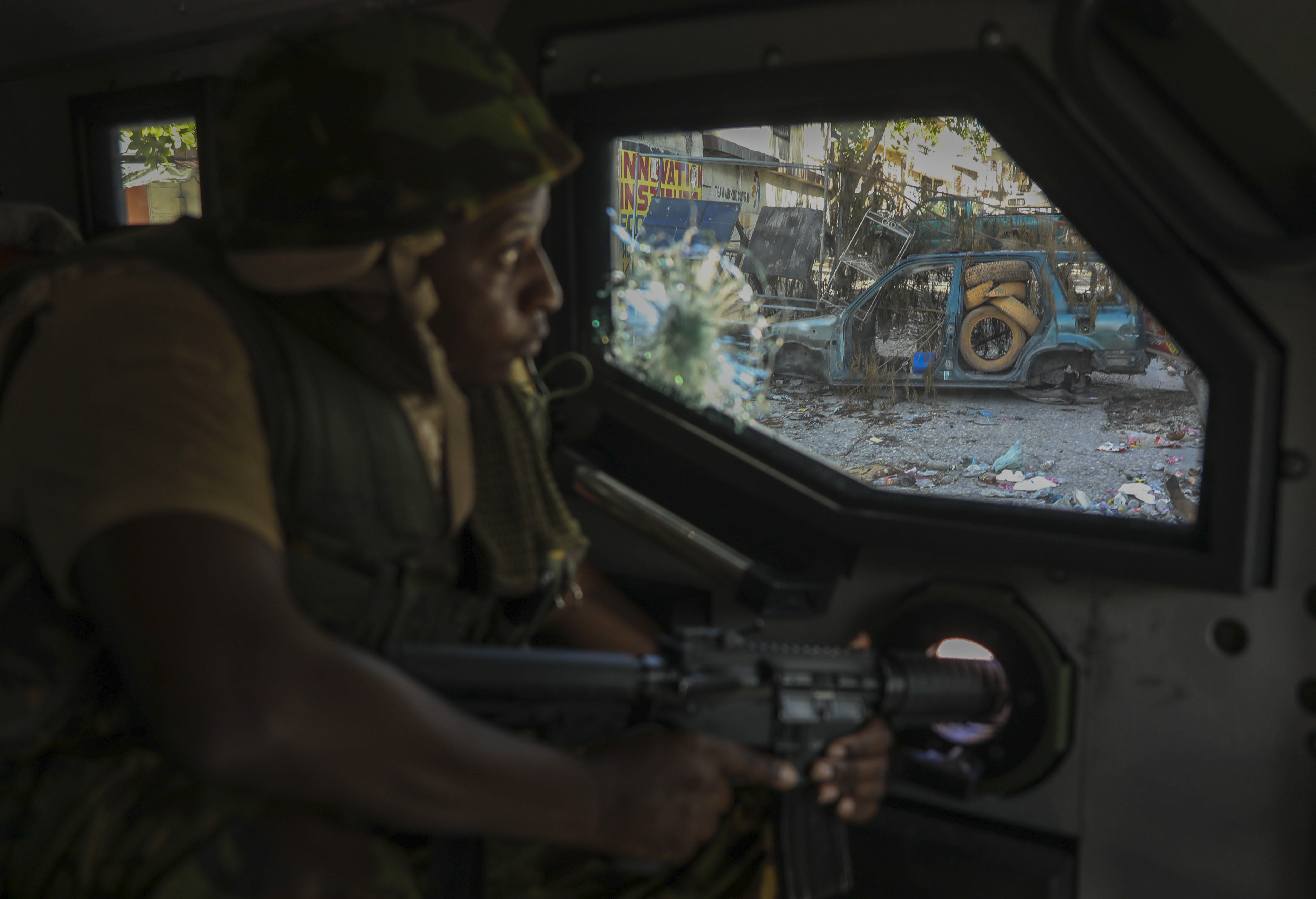 A Kenyan police officer, part of a UN-backed multinational force, patrols a street in Port-au-Prince, Haiti, Dec. 5, 2024. (AP Photo/Odelyn Joseph)