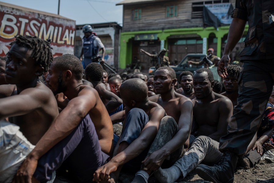 FILE - Arrested members of the Wazalendo sect are sat and lined up in Goma, Democratic Republic of the Congo, on Aug. 30, 2023. (AP Photo/Moses Sawasawa, File)