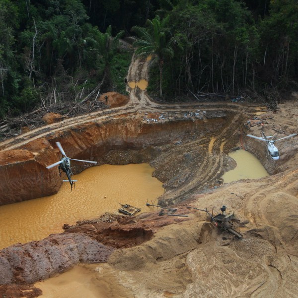 FILE - Brazil Environmental Agency helicopters fly over an illegal mining camp during an operation to try to contain the practice in Yanomami Indigenous territory, Roraima state, Brazil, Feb. 11, 2023. (AP Photo/Edmar Barros, File)