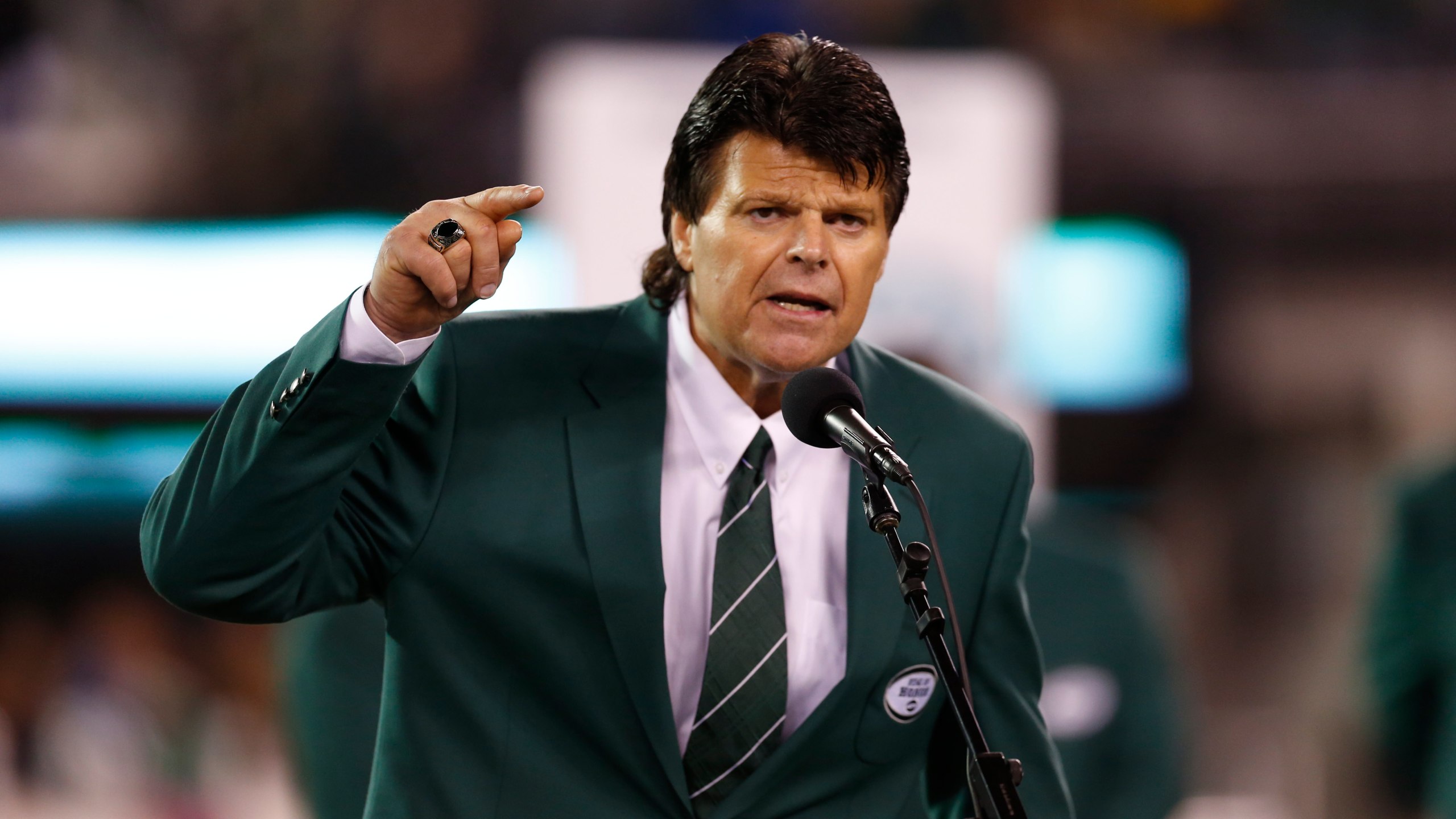 FILE - Former New York Jets defensive end Mark Gastineau gestures during the half time show of an NFL football game between the New York Jets and the Houston Texans Monday, Oct. 8, 2012, in East Rutherford, N.J. (AP Photo/Julio Cortez, File)