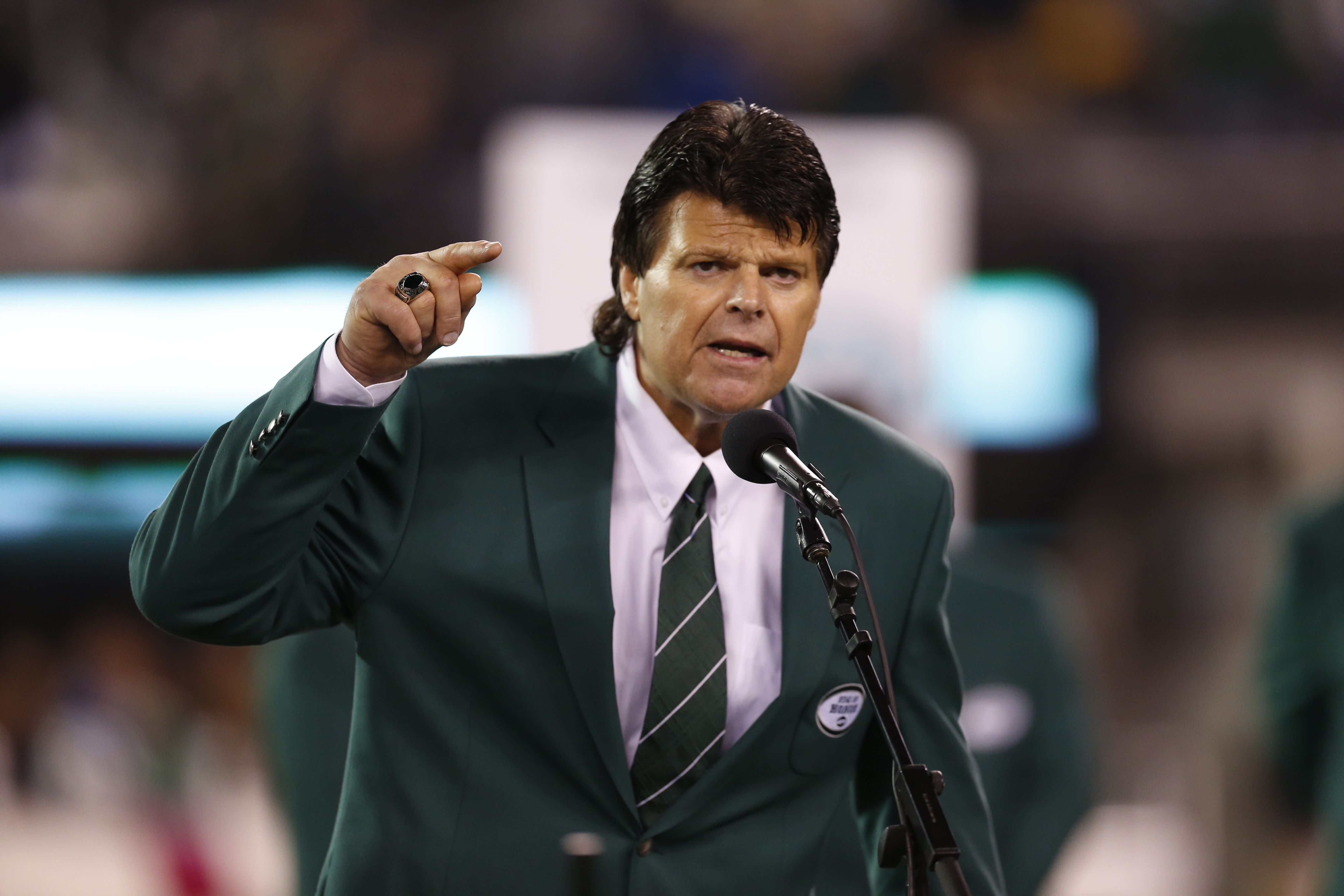 FILE - Former New York Jets defensive end Mark Gastineau gestures during the half time show of an NFL football game between the New York Jets and the Houston Texans Monday, Oct. 8, 2012, in East Rutherford, N.J. (AP Photo/Julio Cortez, File)