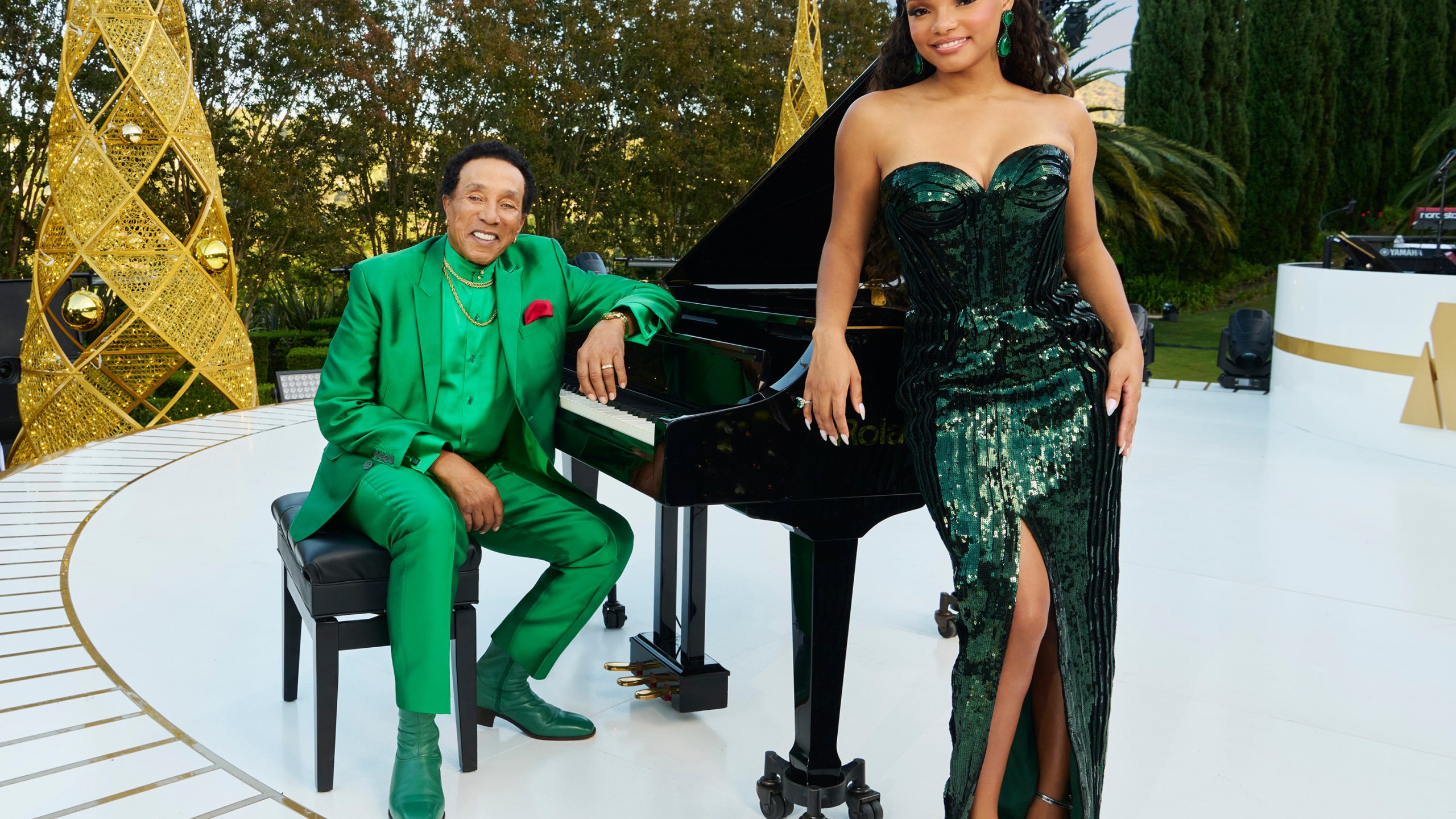 This promotional image released by NBC shows Smokey Robinson, left, and Halle Bailey, who will host the holiday special "A Motown Christmas." (NBCUniversal via AP)