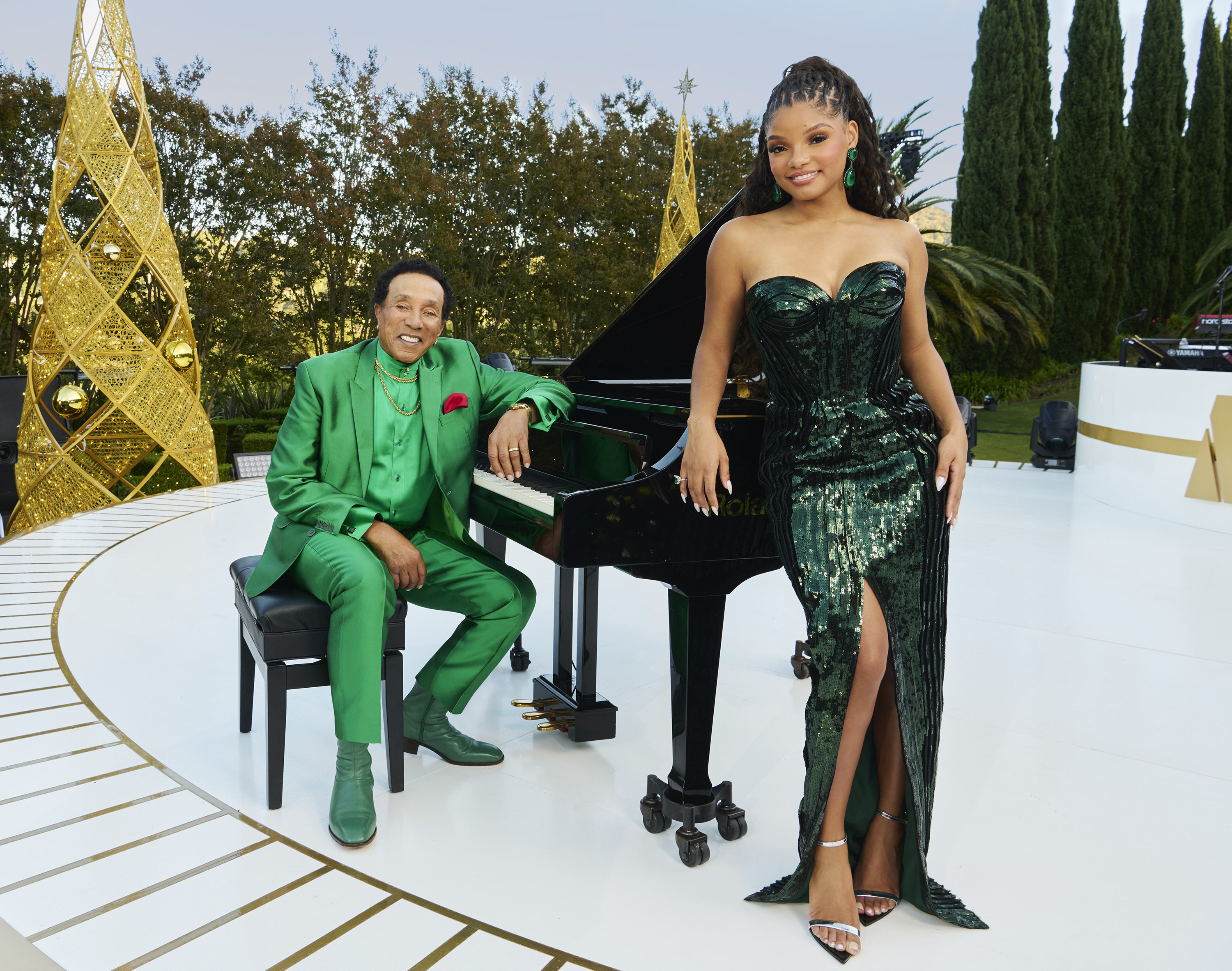 This promotional image released by NBC shows Smokey Robinson, left, and Halle Bailey, who will host the holiday special "A Motown Christmas." (NBCUniversal via AP)