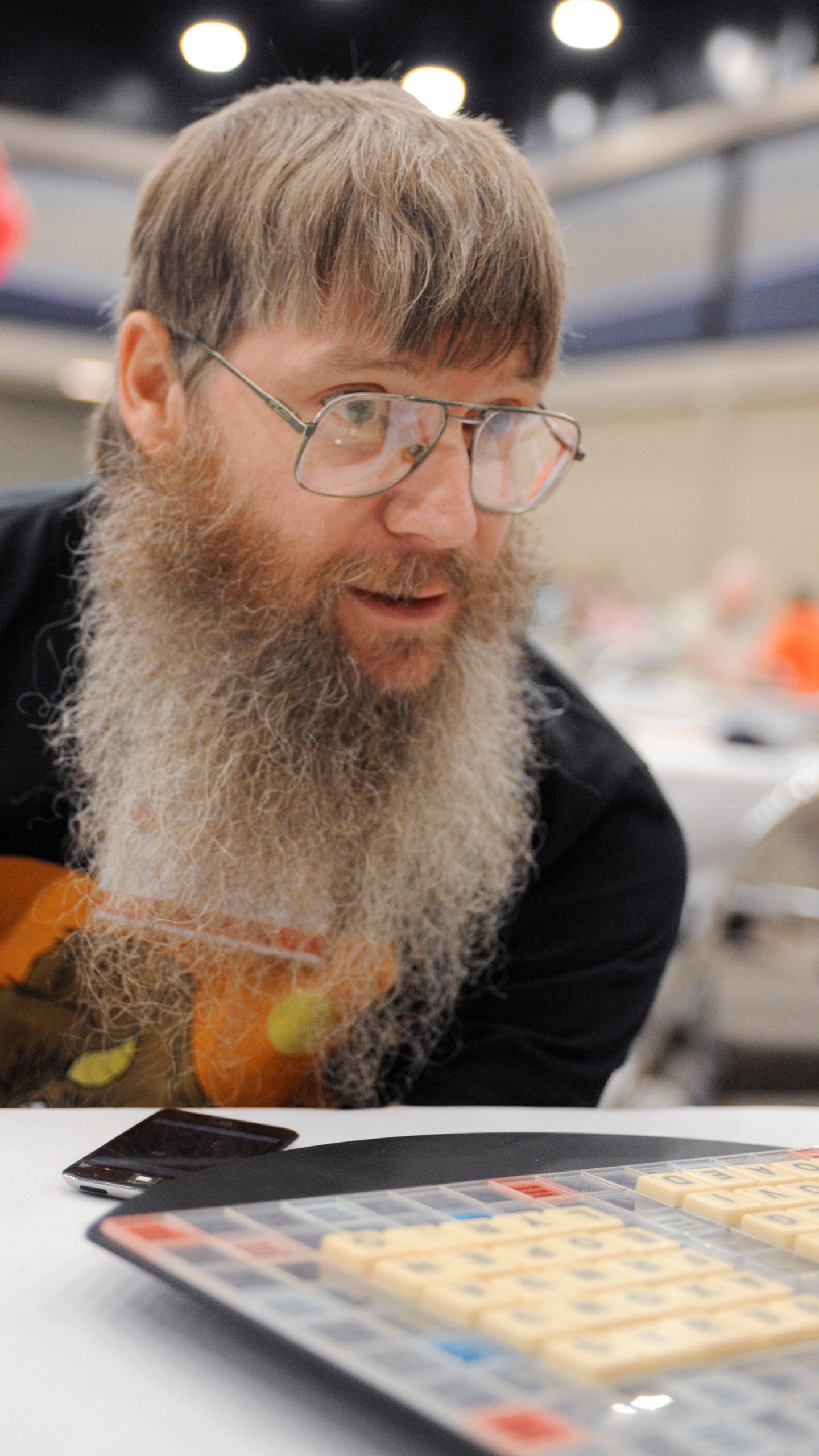 FILE - Tournament favorite and five-time English-language scrabble world champion Nigel Richards looks across the board before the start of his final round, Wednesday, Aug. 13, 2014, at the National Scrabble Championships in Buffalo, N.Y. (AP Photo/Gary Wiepert, File)