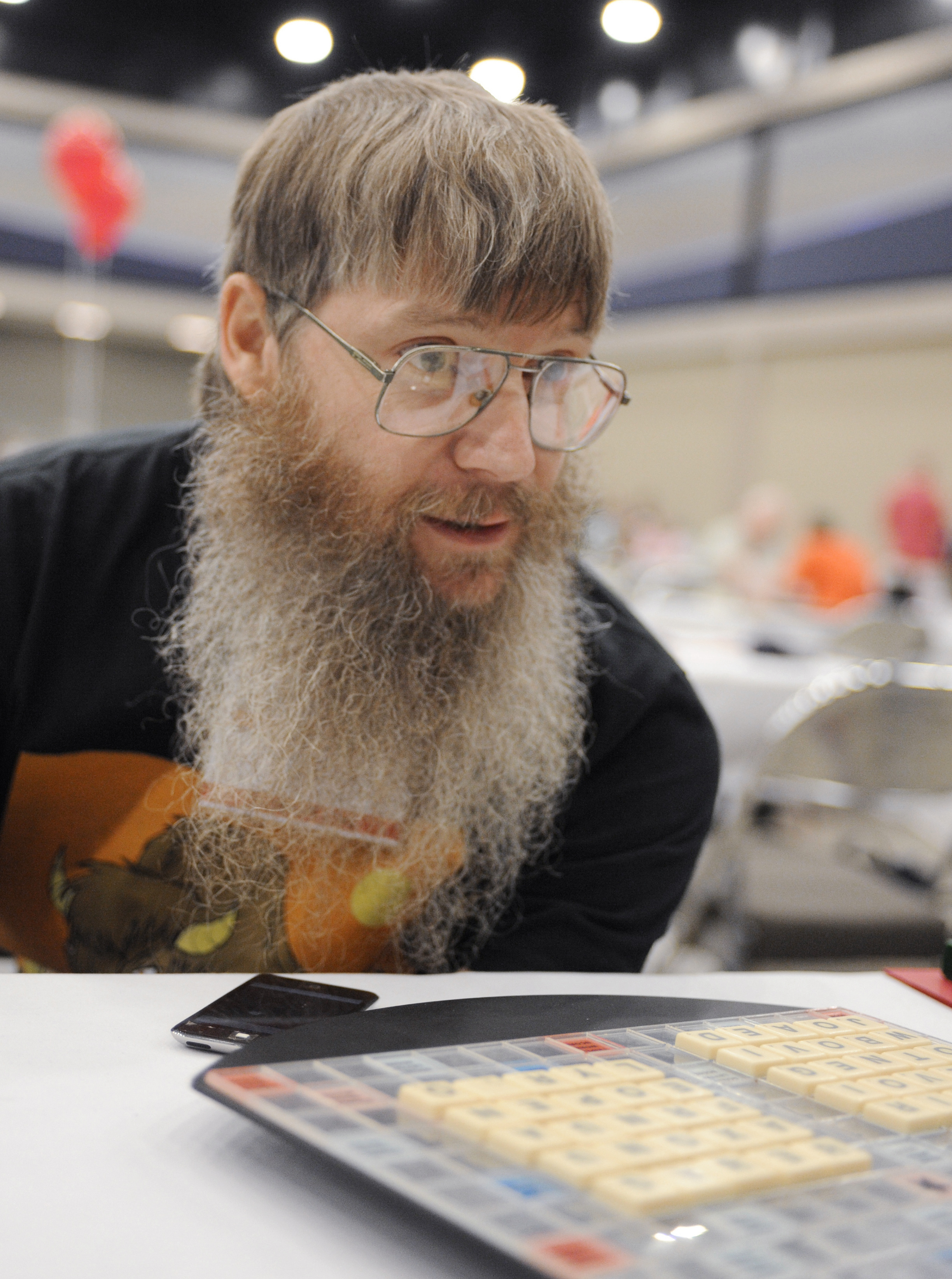 FILE - Tournament favorite and five-time English-language scrabble world champion Nigel Richards looks across the board before the start of his final round, Wednesday, Aug. 13, 2014, at the National Scrabble Championships in Buffalo, N.Y. (AP Photo/Gary Wiepert, File)