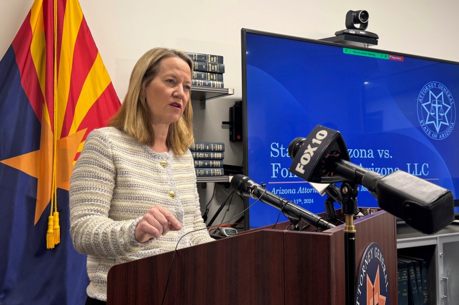 Arizona Attorney General Kris Mayes announces she's suing a Saudi Arabian company for allegedly pumping groundwater that harms local communities in a rural western county, Wednesday, Dec. 11, 2024, in Phoenix. (AP Photo/Gabriel Sandoval)