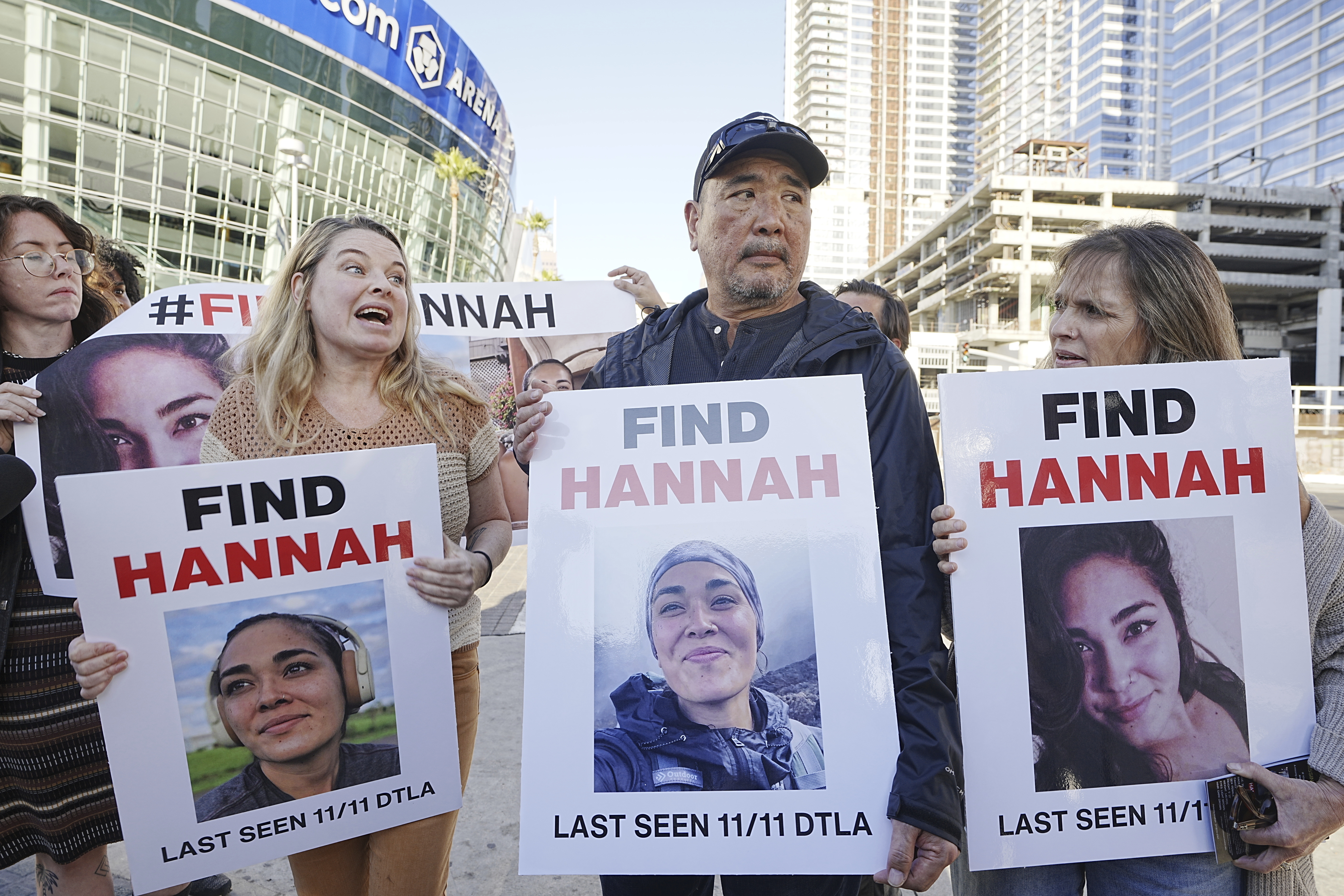 FILE - Ryan Kobayashi, center, holds a picture of his missing daughter Hannah Kobayashi outside Crypto.com Arena, Thursday, Nov. 21, 2024 in Los Angeles. (AP Photo/Damian Dovarganes, File)