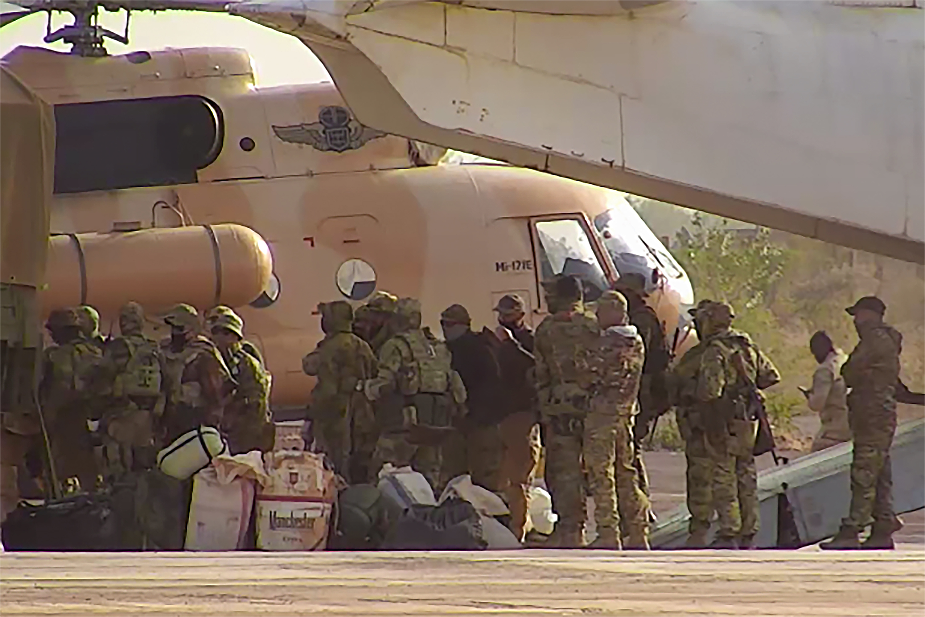 FILE - This undated photograph released in April 2022 by France's military shows Russian mercenaries boarding a helicopter in northern Mali. (French Army via AP, File)