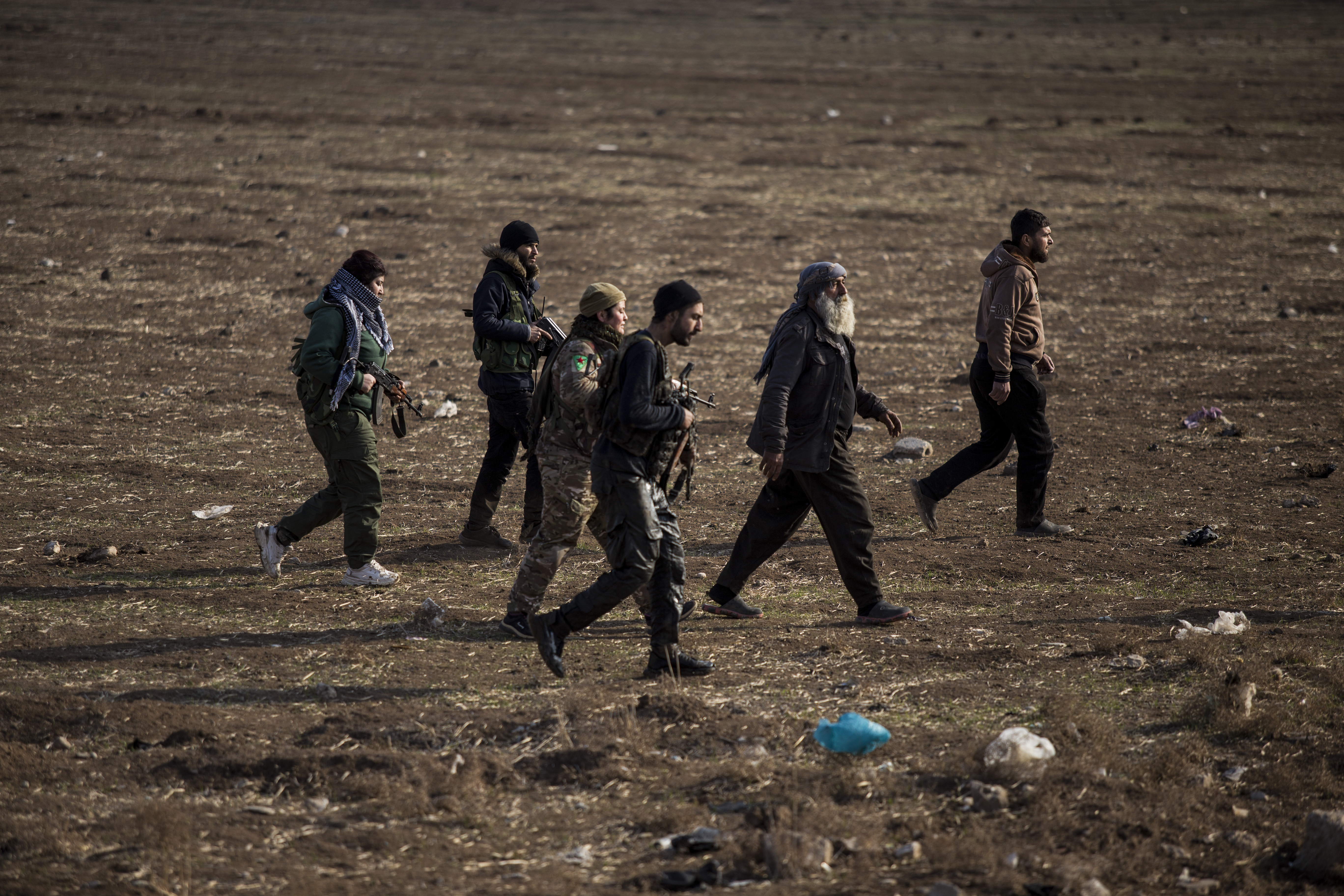 FILE - Kurdish-led fighters backed by the U.S. escort suspected Islamic State militants in Hassakeh, Syria, on Jan. 26, 2022. (AP Photo/Baderkhan Ahmad, File)