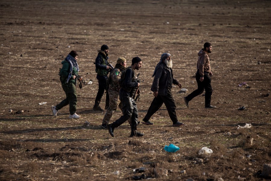 FILE - Kurdish-led fighters backed by the U.S. escort suspected Islamic State militants in Hassakeh, Syria, on Jan. 26, 2022. (AP Photo/Baderkhan Ahmad, File)