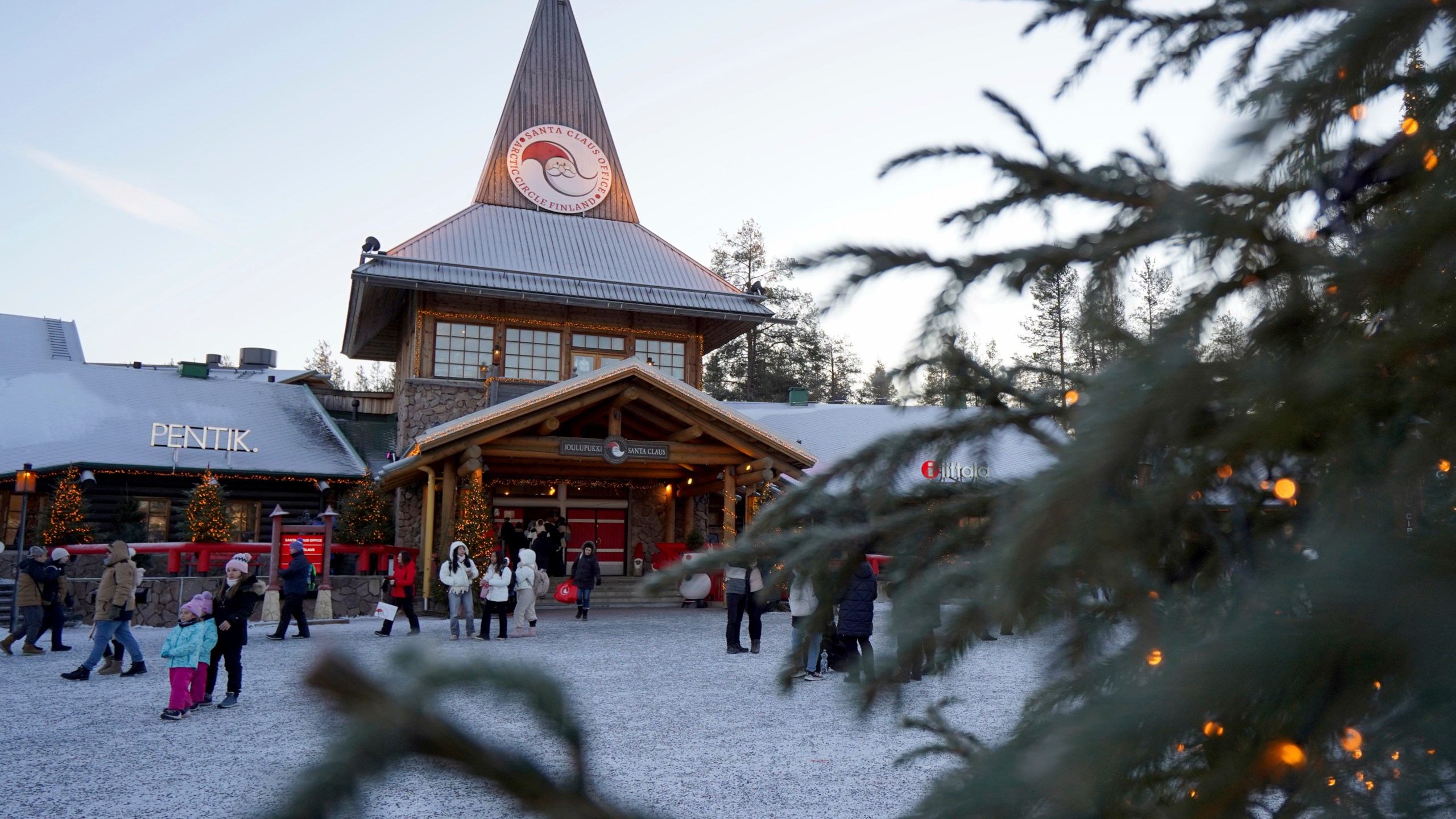 Tourists gathered at Santa Claus Village, a winter-themed amusement park perched on the edge of the Arctic Circle, in Rovaniemi, Finland, Wednesday, Dec. 4, 2024. (AP Photo/James Brooks)