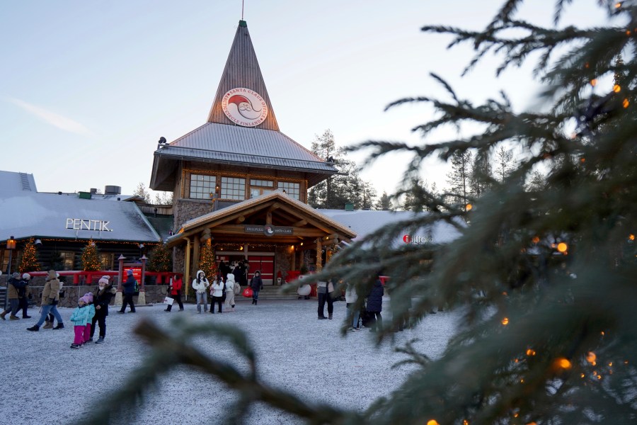 Tourists gathered at Santa Claus Village, a winter-themed amusement park perched on the edge of the Arctic Circle, in Rovaniemi, Finland, Wednesday, Dec. 4, 2024. (AP Photo/James Brooks)