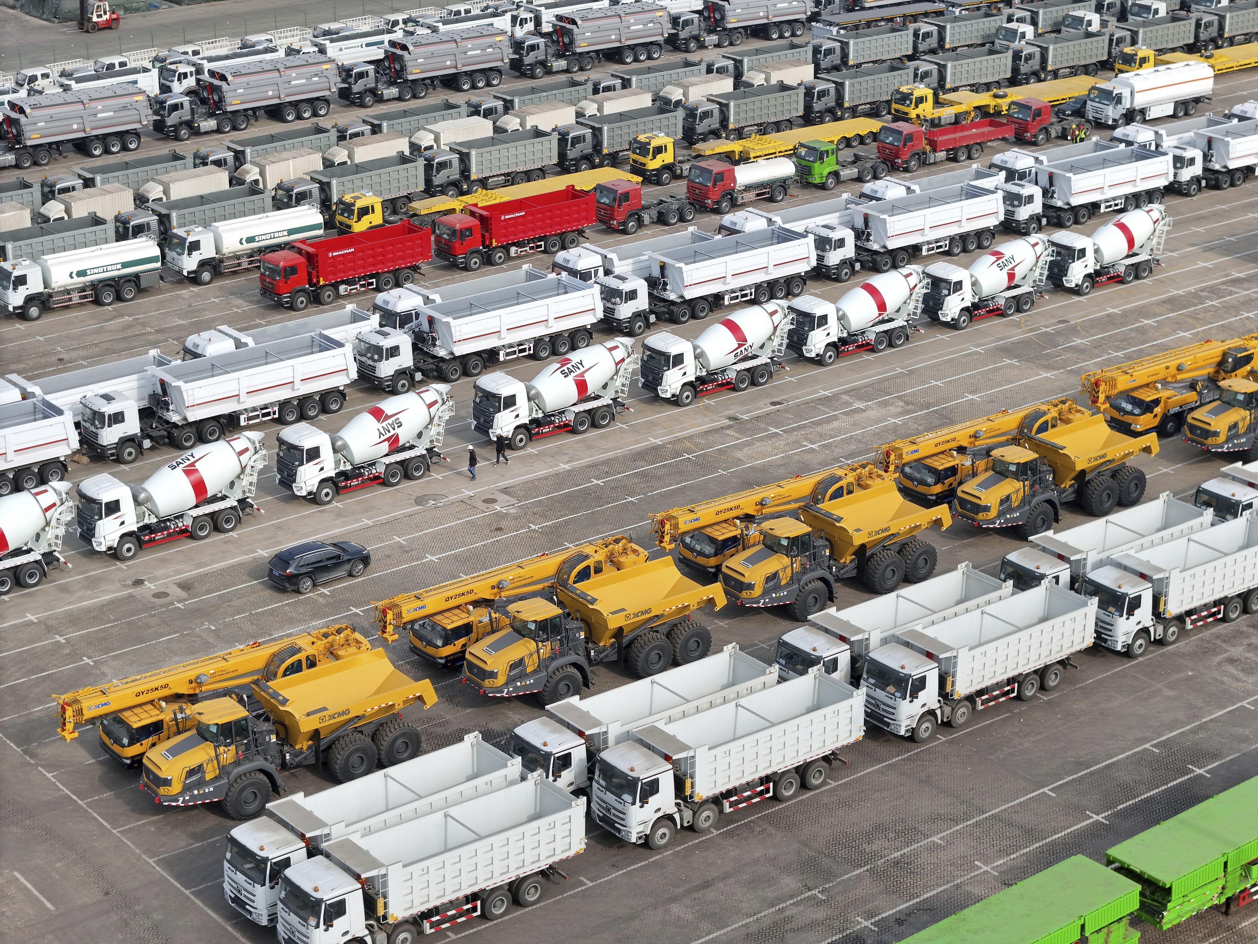 Trucks and engineering vehicles for export wait for transportation from a port in Yantai in eastern China's Shandong province Tuesday, Nov. 19, 2024. (Chinatopix Via AP)