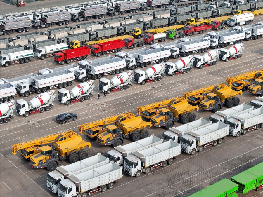 Trucks and engineering vehicles for export wait for transportation from a port in Yantai in eastern China's Shandong province Tuesday, Nov. 19, 2024. (Chinatopix Via AP)