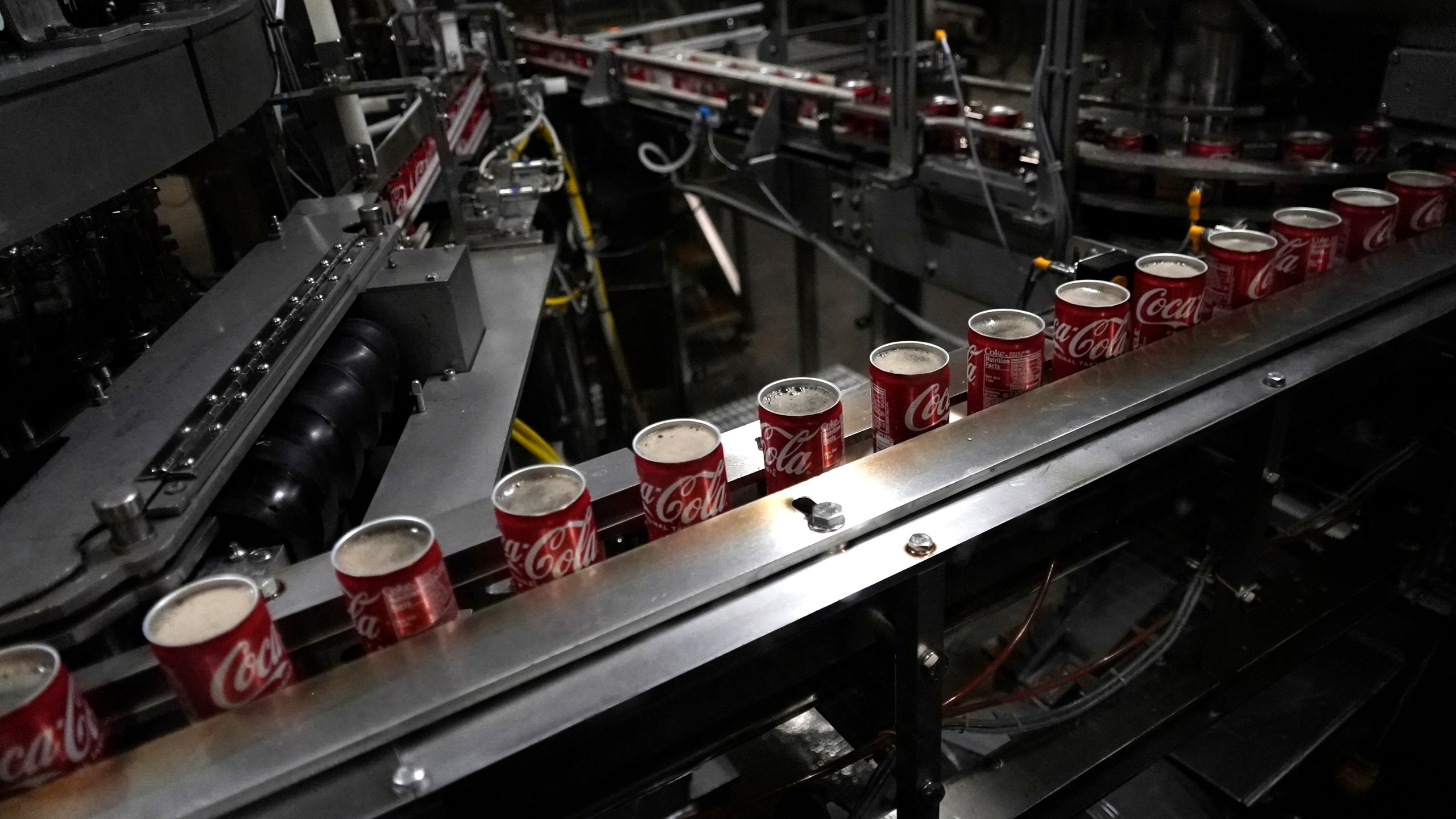 FILE - Coca-Cola cans move down a conveyer belt in the Swire Coca-Cola bottling plant Oct. 20, 2023, in Denver. (AP Photo/Brittany Peterson, File)