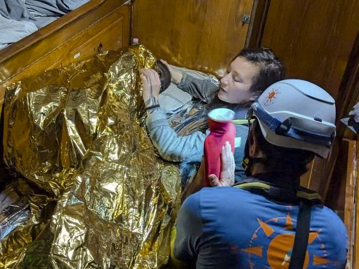 In this image made available on Thursday, Dec. 12, 2024, by CompassCollective, rescuers attend to an 11-year-old girl from Sierra Leone who was found floating in the Mediterranean Sea off Italy's southernmost Lampedusa island, and is believed to be the only survivor of a shipwrecked migrant boat that had departed from the port of Sfax in Tunisia. (AP Photo/CompassCollective, HO)