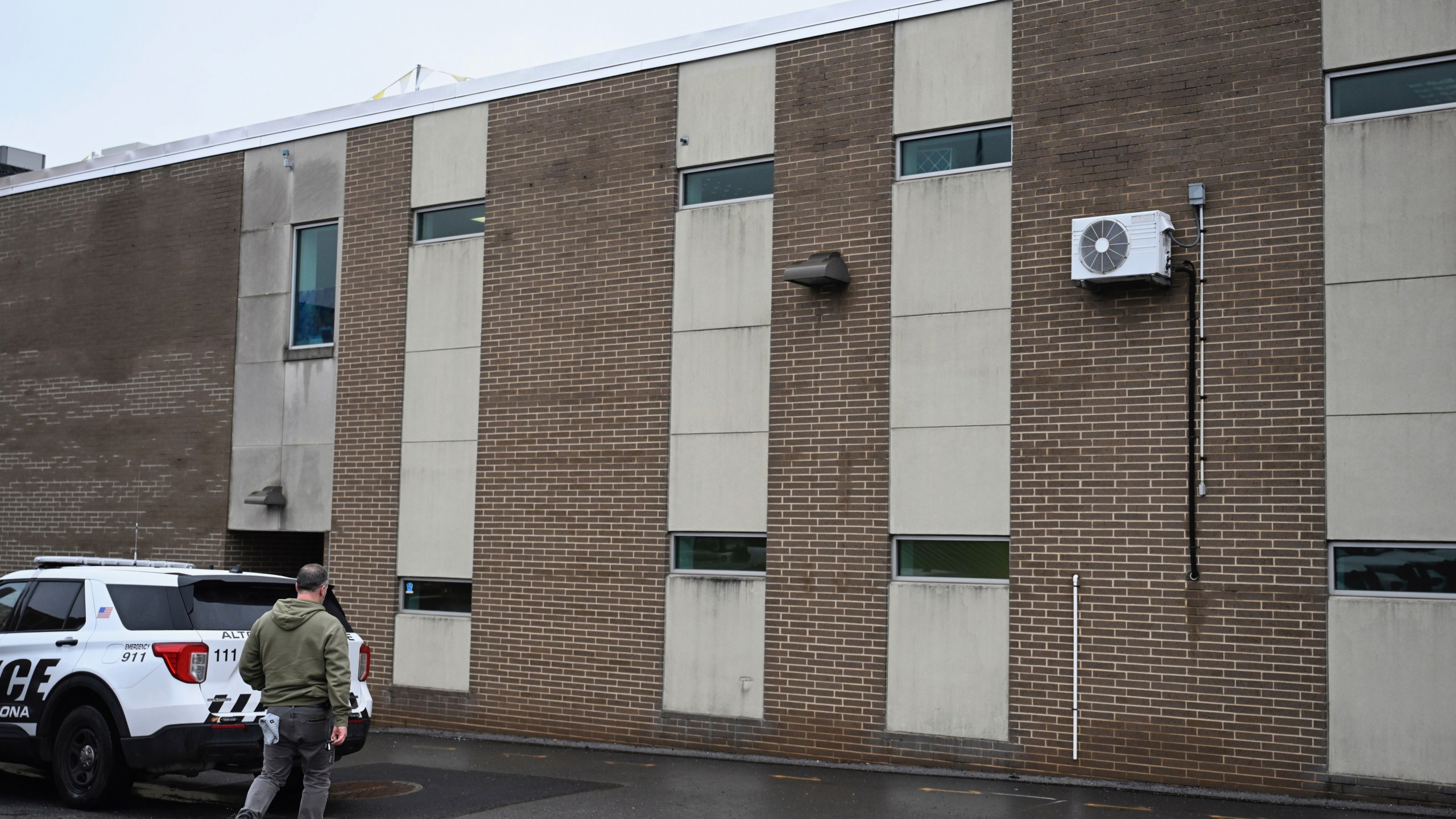 A law enforcement officer walks into the Altoona Police Department, where suspect in the UnitedHealthcare CEO shooting, 26-year old Luigi Mangione is being held Monday, Dec. 9, 2024, Altoona, Pa. (Benjamin B. Braun/Pittsburgh Post-Gazette via AP)