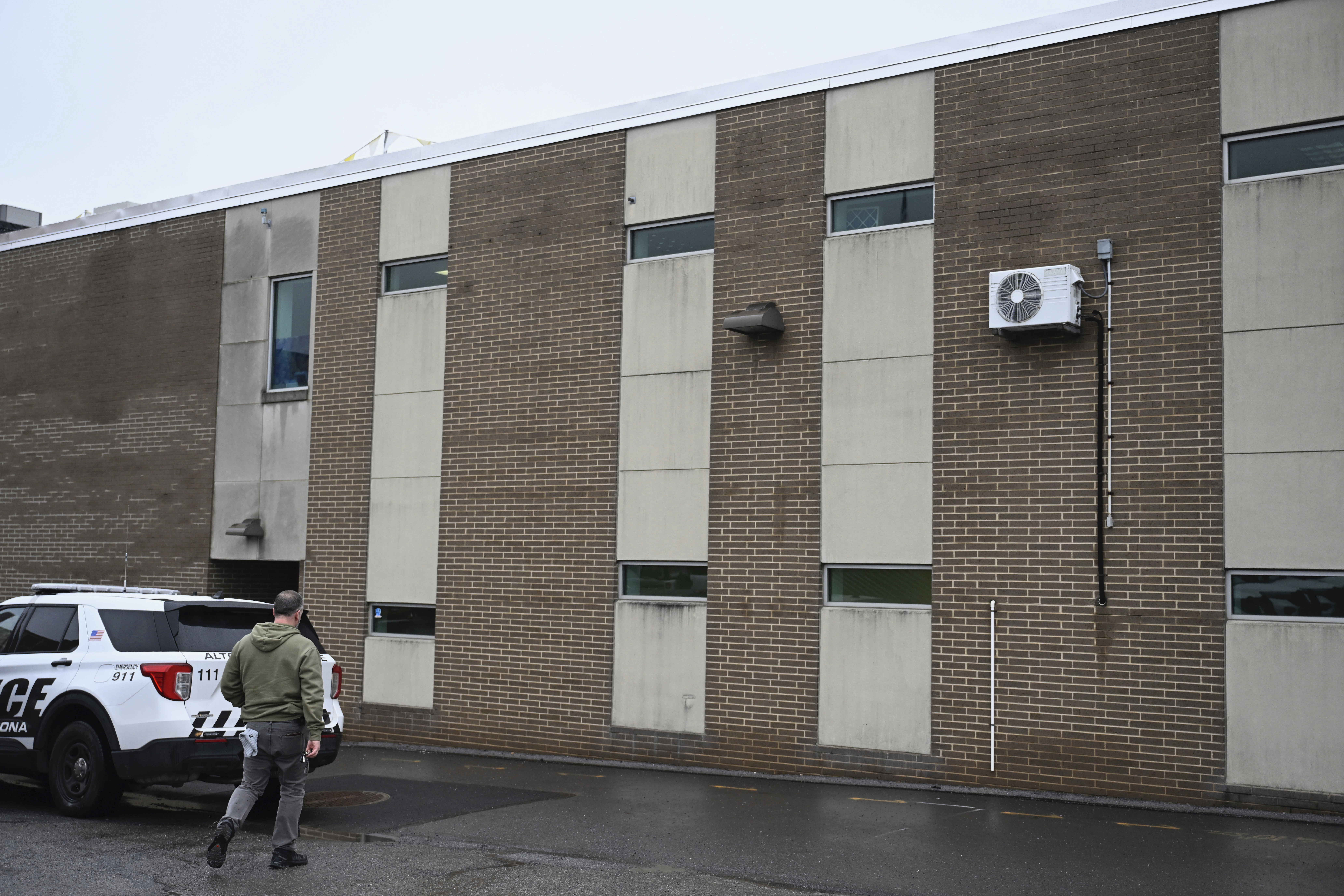 A law enforcement officer walks into the Altoona Police Department, where suspect in the UnitedHealthcare CEO shooting, 26-year old Luigi Mangione is being held Monday, Dec. 9, 2024, Altoona, Pa. (Benjamin B. Braun/Pittsburgh Post-Gazette via AP)