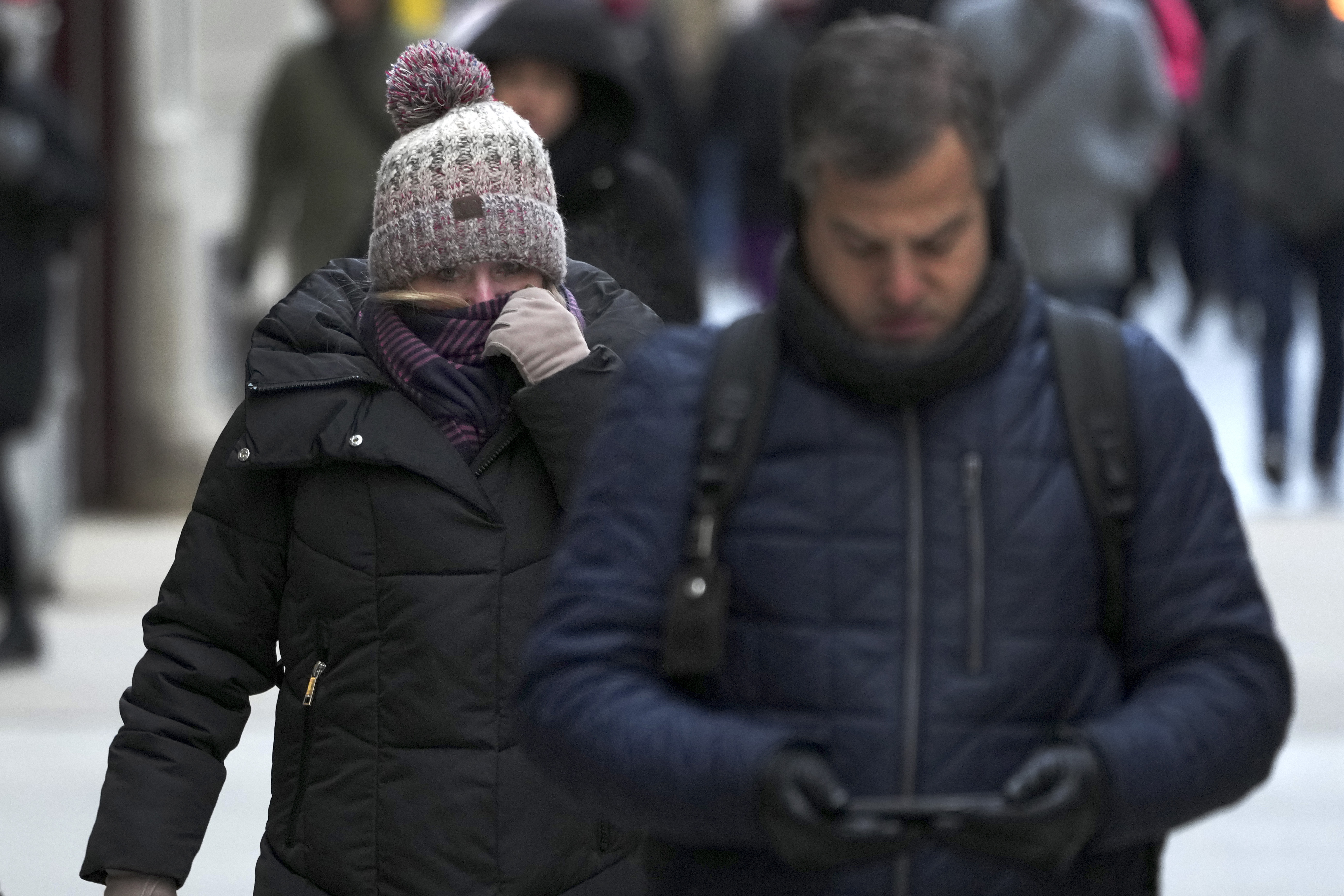 Commuters head to work as an Arctic blast brings single-digit temperatures with wind chills below zero on Thursday, Dec. 12, 2024, in Chicago. (AP Photo/Charles Rex Arbogast)