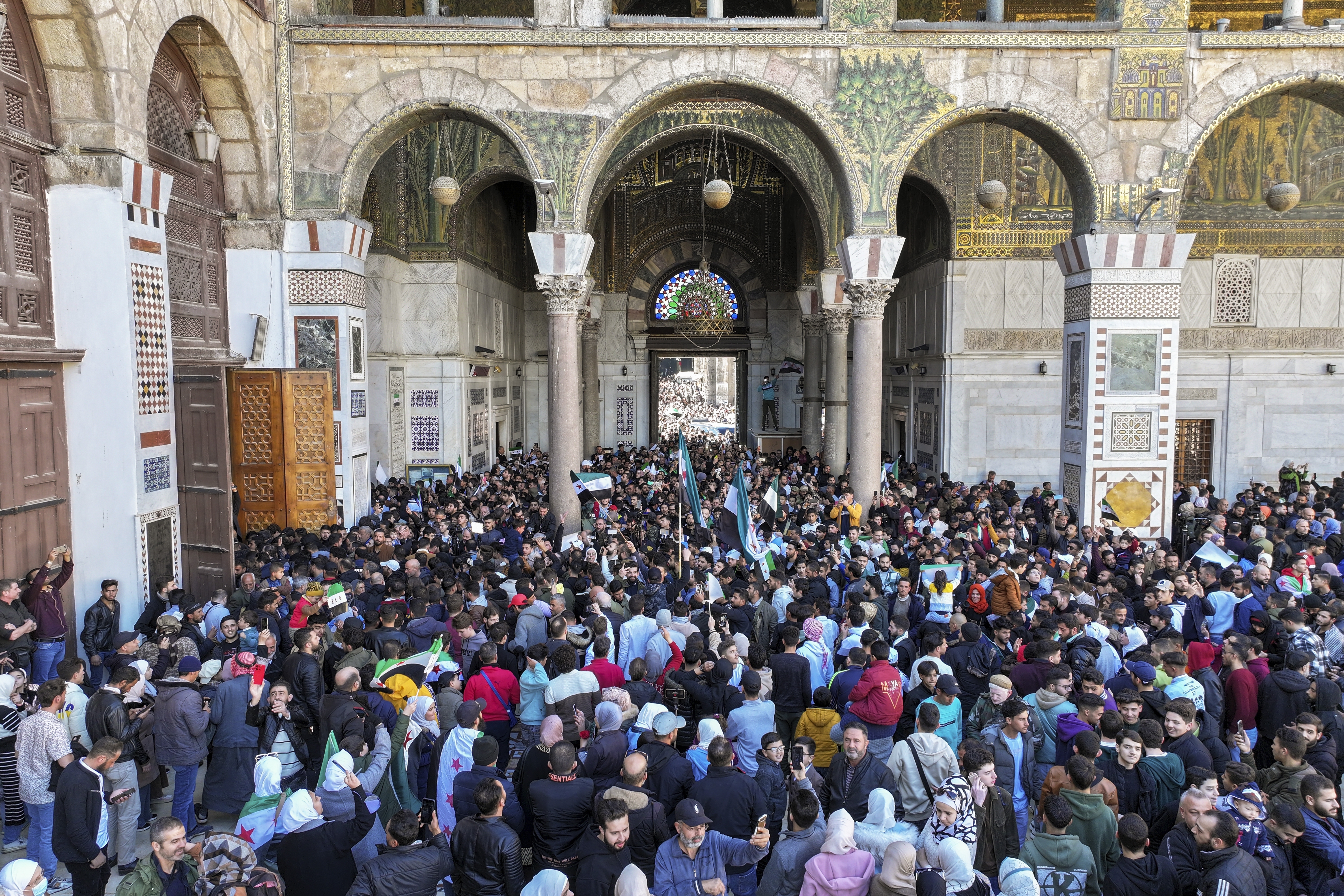 Syrians gather outside the Umayyad mosque to attend first Friday prayers since Bashar Assad's ouster, in Damascus, Syria, Friday, Dec. 13, 2024. (AP Photo/Ghaith Alsayed)