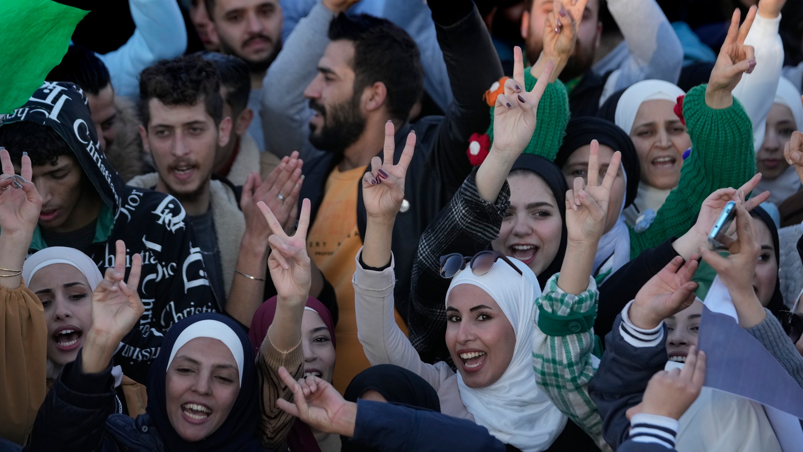 Syrians celebrate during a demonstration following the first Friday prayers since Bashar Assad's ouster, in Damascus' central square, Syria, on Friday, Dec. 13, 2024. (AP Photo/Hussein Malla)