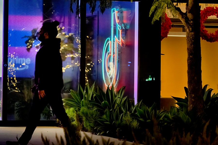 A neon TikTok logo hangs in the lobby of the TikTok office building in Culver City, Calif., on Tuesday, Dec. 3, 2024. (AP Photo/Richard Vogel)