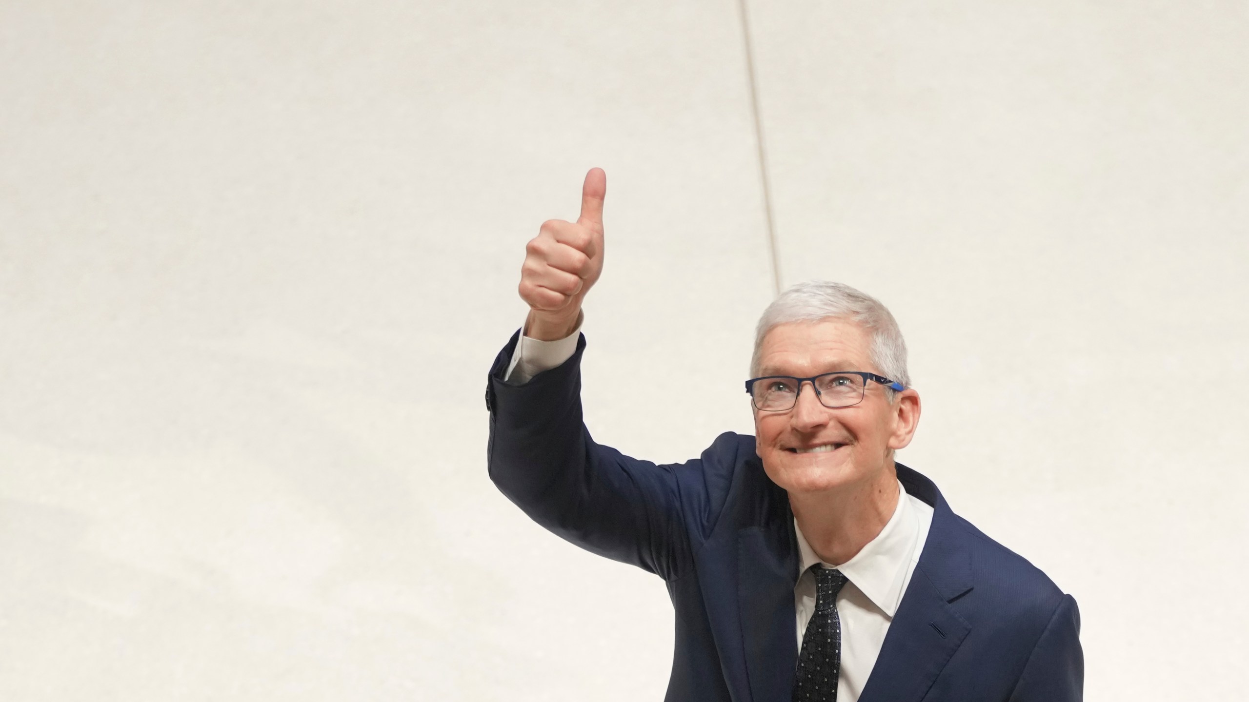 Apple CEO Tim Cook gestures as he accompanies Britain's King Charles III during a visit at Apple's UK Headquarters Battersea Power Station office in London, Thursday, Dec. 12, 2024. (AP Photo/Kin Cheung, Pool)