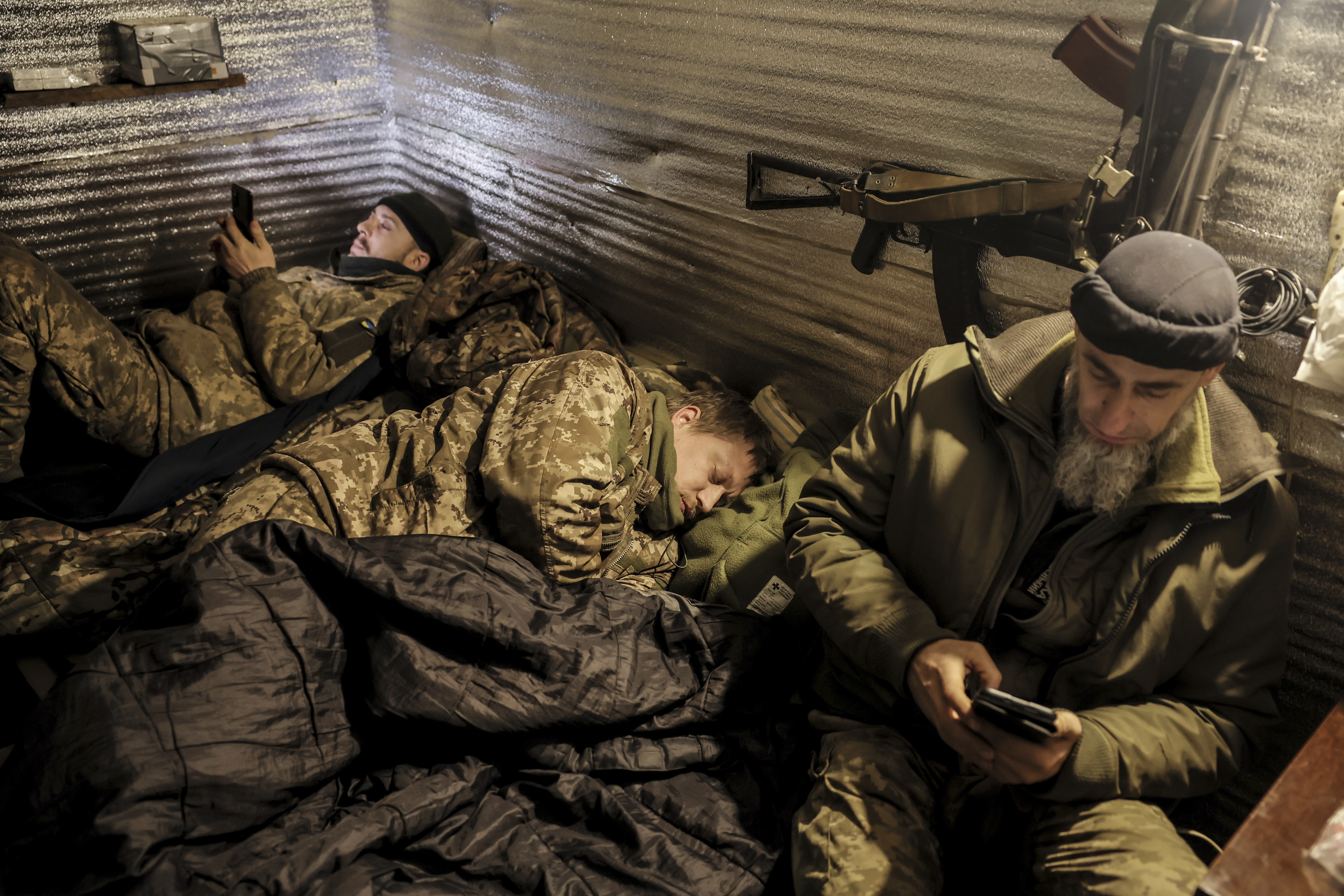 In this photo provided by Ukraine's 24th Mechanized Brigade press service, servicemen of the 24th Mechanised Brigade rest in a shelter on the front line near Chasiv Yar town, in Donetsk region, Ukraine, Thursday, Dec. 12, 2024. (Oleg Petrasiuk/Ukrainian 24th Mechanised Brigade via AP)