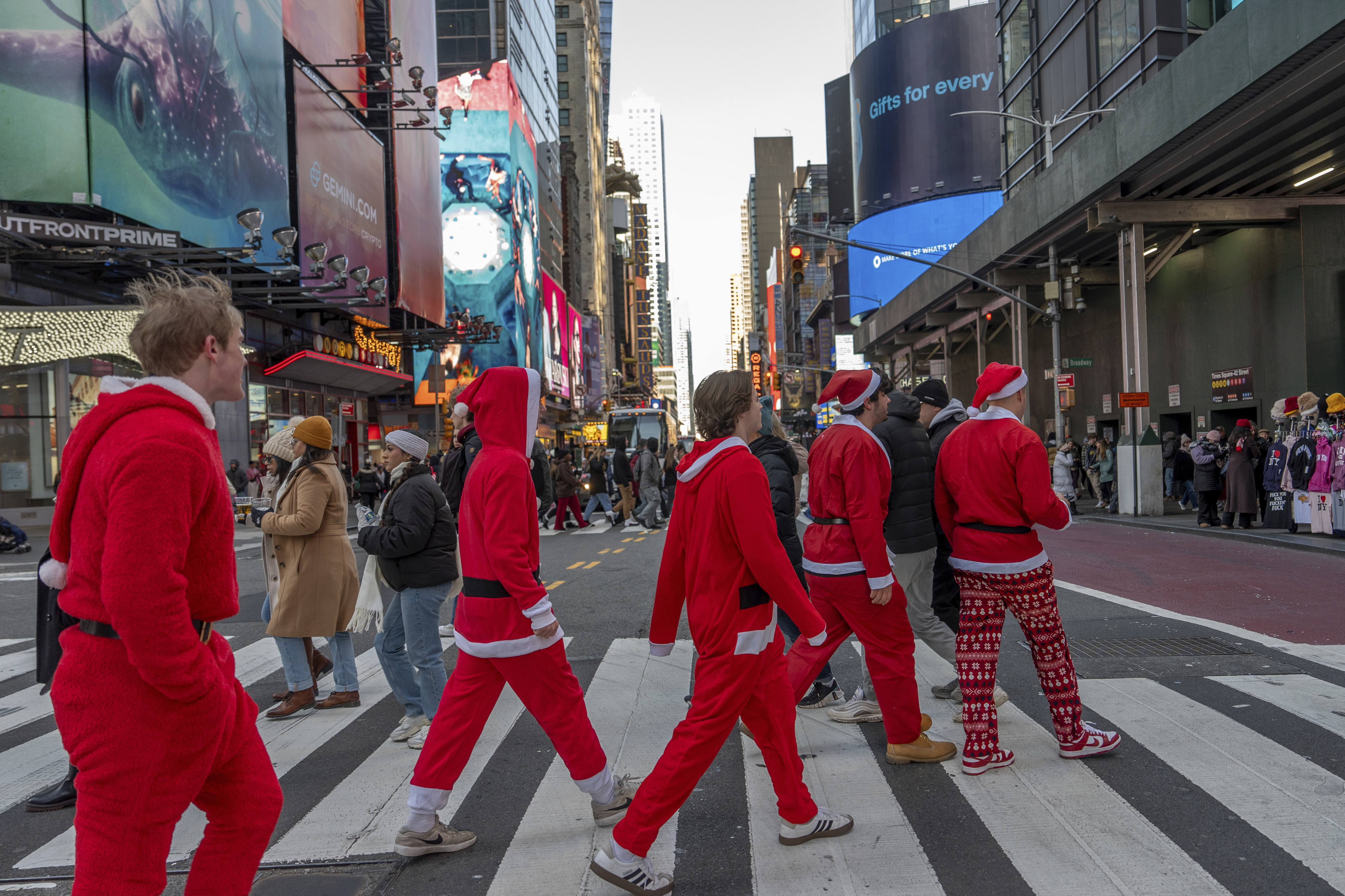 Revellers take part in SantaCon, Saturday, Dec. 14, 2024, in New York. (AP Photo/Julia Demaree Nikhinson)