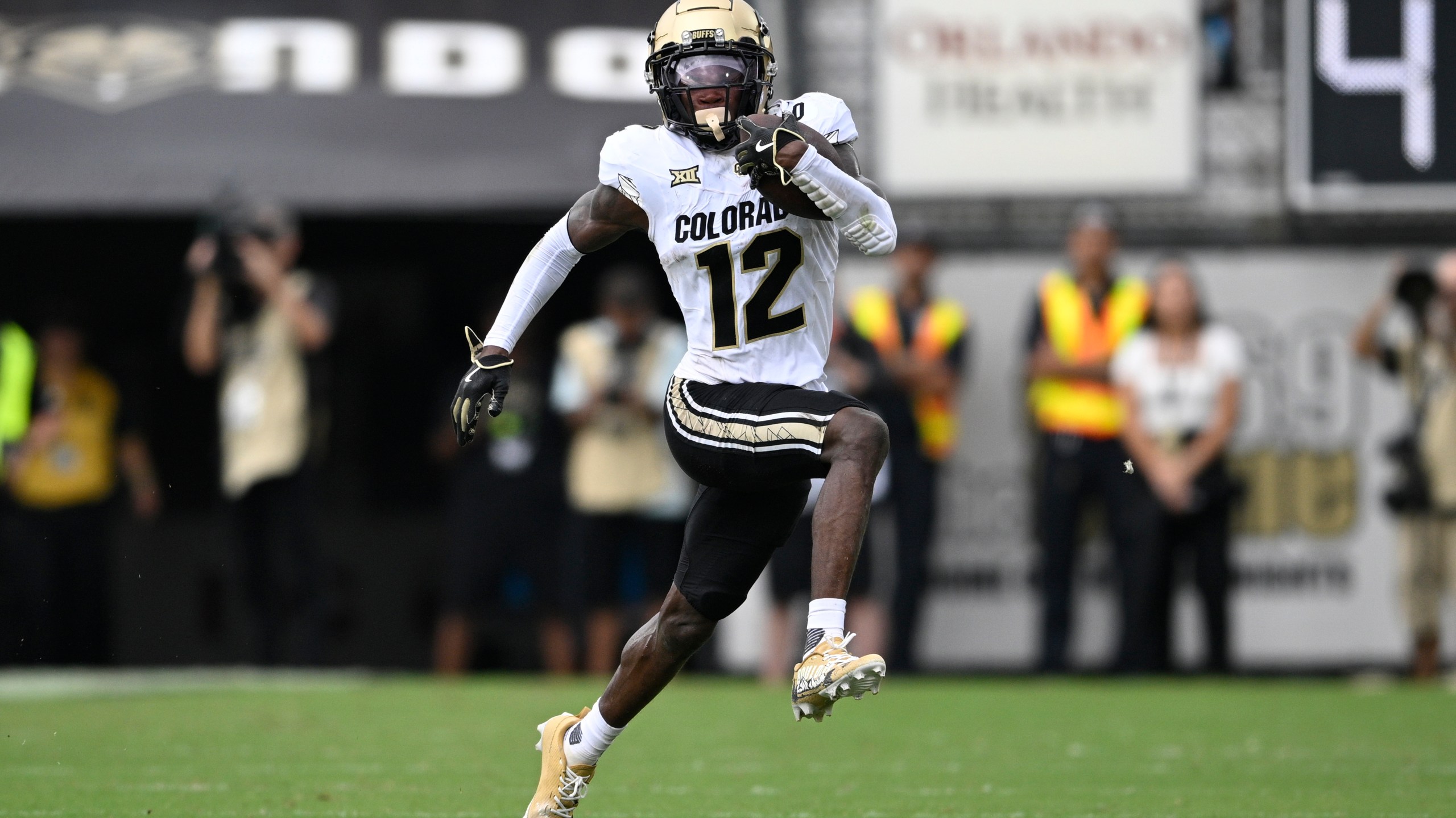 FILE - Colorado wide receiver Travis Hunter (12) runs after catching a pass during the first half of an NCAA college football game against Central Florida, Saturday, Sept. 28, 2024, in Orlando, Fla. (AP Photo/Phelan M. Ebenhack, File)