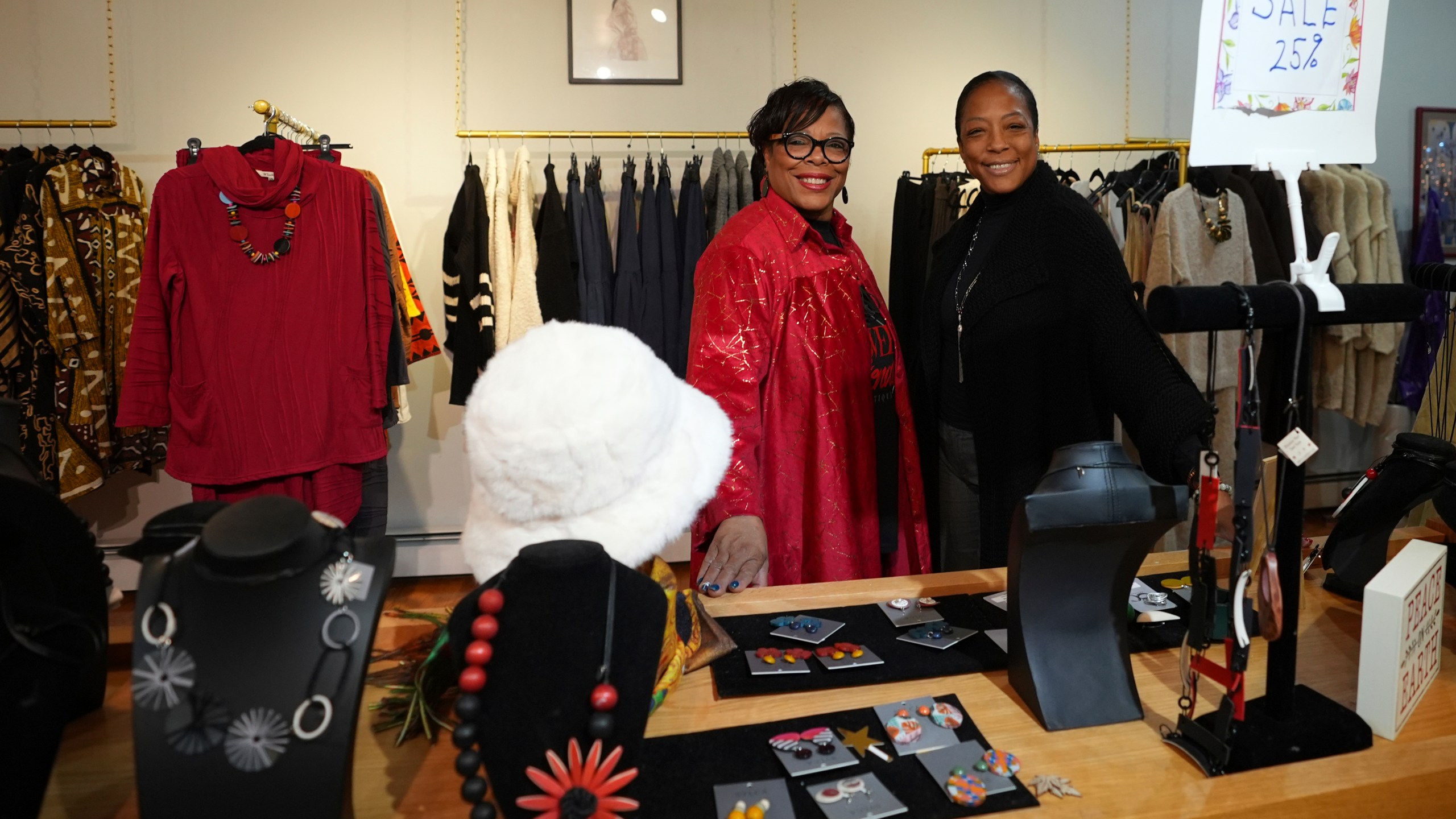 Claudia Averette, left, and her daughter, Atiya Smith pose for a photograph at their shop, Between Friends Boutique, Wednesday, Dec. 11, 2024, in Philadelphia. (AP Photo/Matt Slocum)