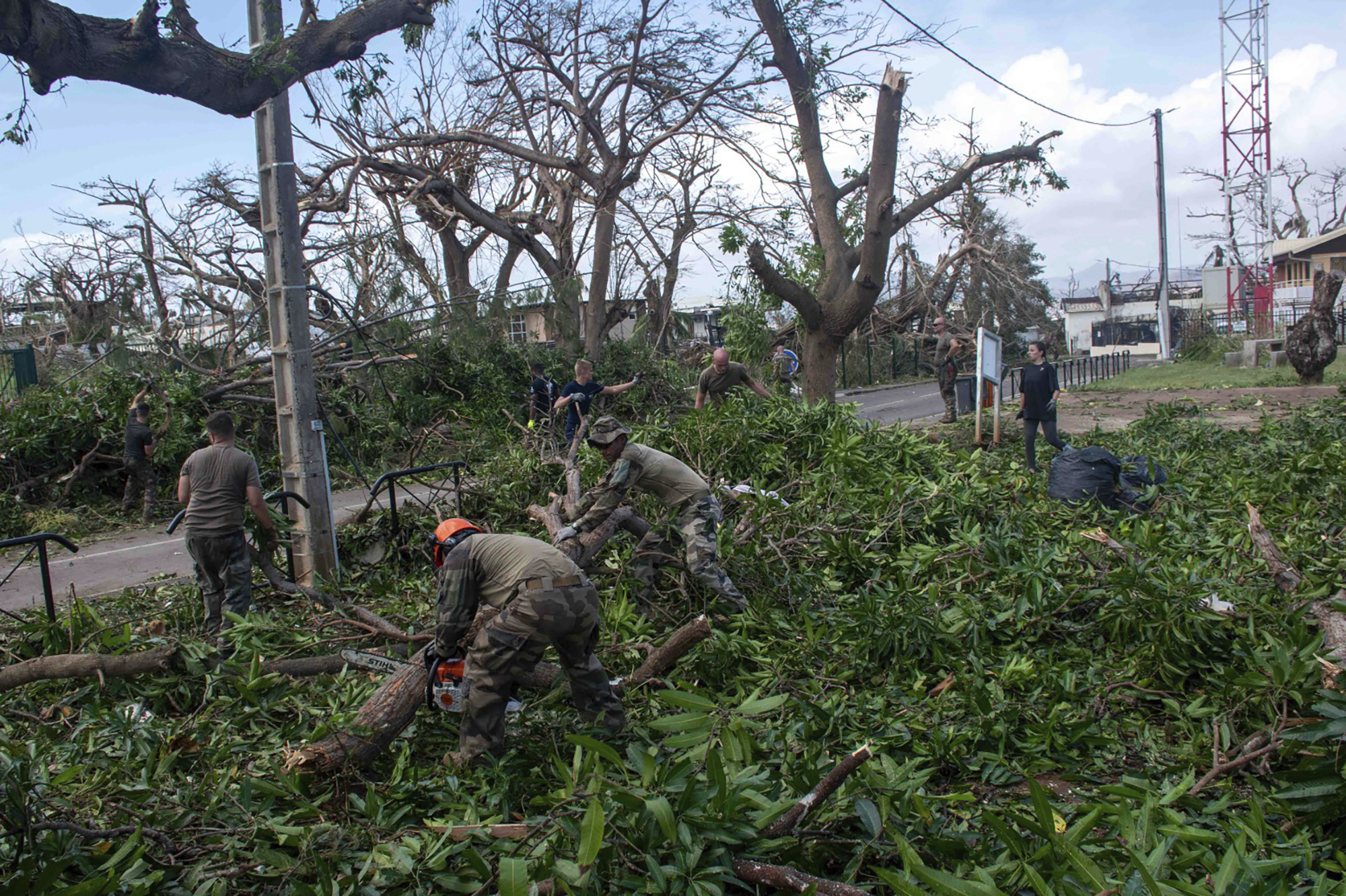 This photo provided Sunday Dec.15, 2024 by the French Army shows soldiers removing fallen trees in the French territory of Mayotte in the Indian Ocean, after Cyclone Chido caused extensive damage with reports of several fatalities. (Etat Major des Armées via AP)