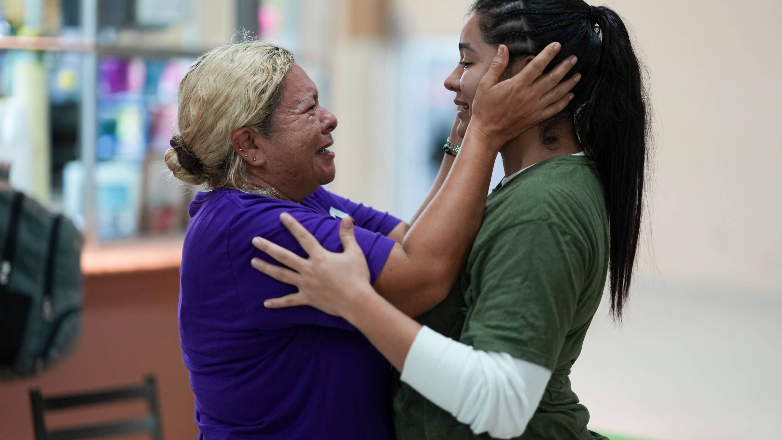 Honduran migrant Kimberly Orellana, right, greets her mother Oralia Mejía after being deported from the U.S., at a bus station in San Pedro Sula, Honduras, Wednesday, Dec. 4, 2024. (AP Photo/Moises Castillo)