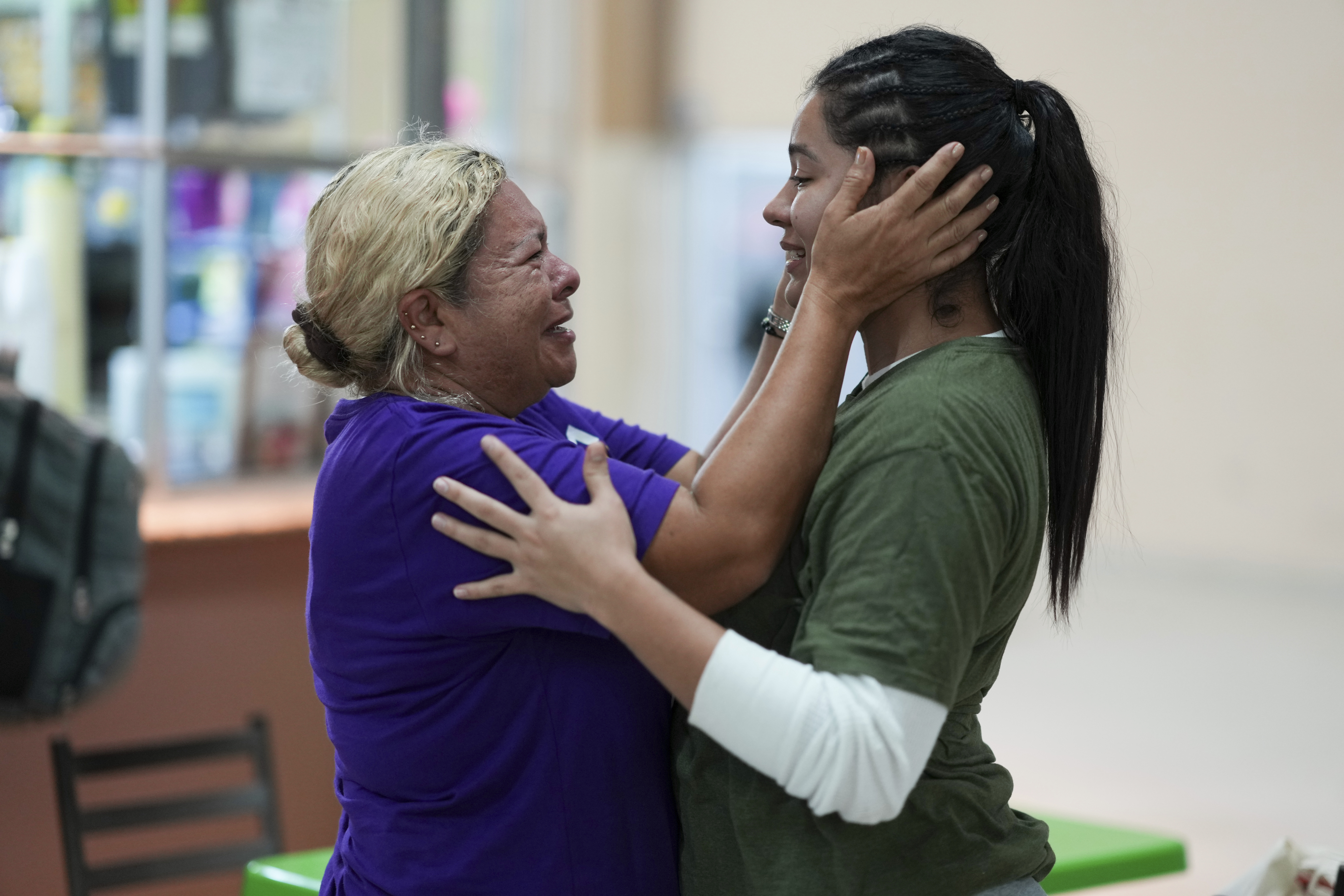 Honduran migrant Kimberly Orellana, right, greets her mother Oralia Mejía after being deported from the U.S., at a bus station in San Pedro Sula, Honduras, Wednesday, Dec. 4, 2024. (AP Photo/Moises Castillo)