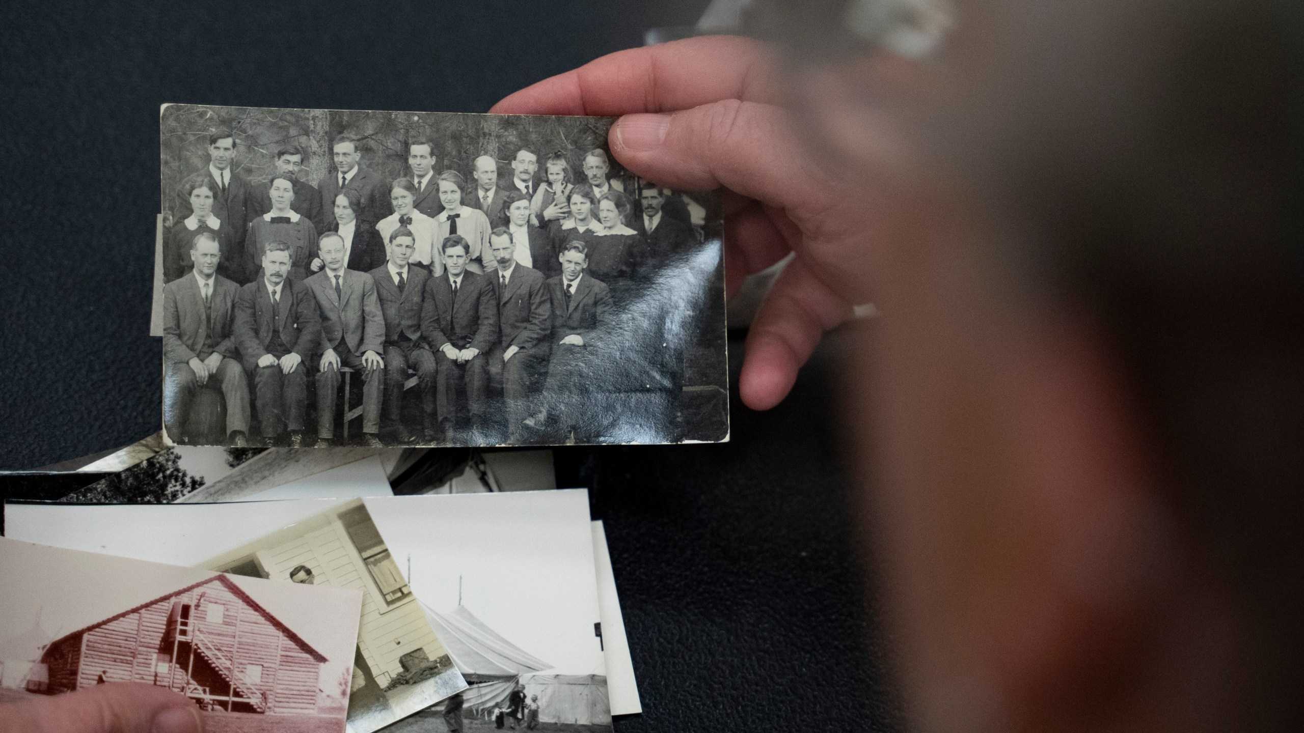 Pam Walton holds a photograph of “Two by Twos” ministers, also referred to as “workers,” at a library Monday, Dec. 9, 2004, in Wailea, Hawaii. Walton uses historic photos and other records to track the movements of spiritual leaders facing allegations of child sexual abuse within the sect. (AP Photo/Mengshin Lin)