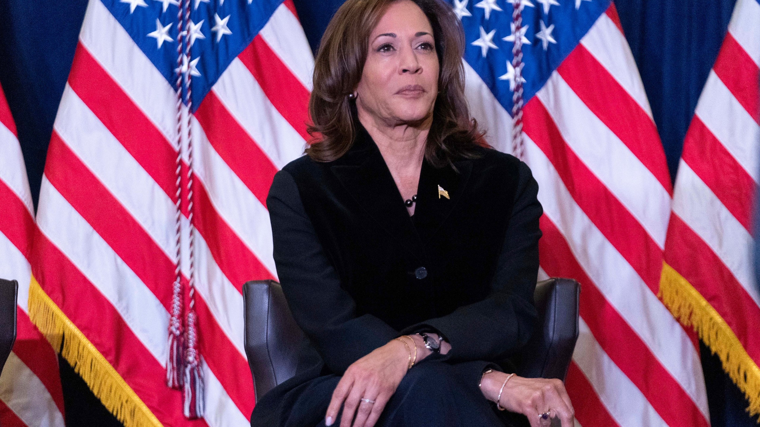 Vice President Kamala Harris listens as first lady Jill Biden speaks at the Democratic National Committee's Holiday Reception at Willard Hotel in Washington, Sunday, Dec. 15, 2024. (AP Photo/Jose Luis Magana)