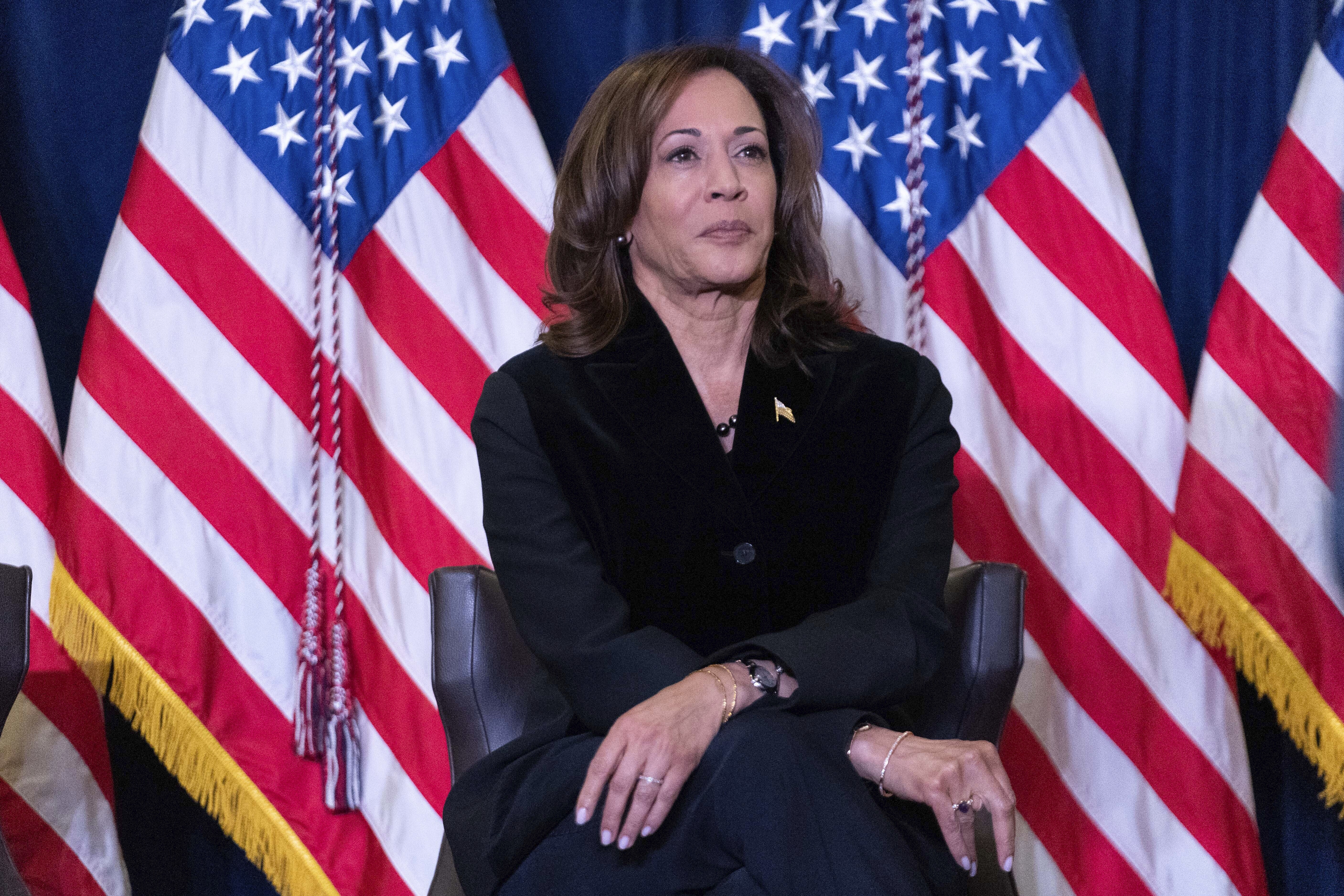 Vice President Kamala Harris listens as first lady Jill Biden speaks at the Democratic National Committee's Holiday Reception at Willard Hotel in Washington, Sunday, Dec. 15, 2024. (AP Photo/Jose Luis Magana)