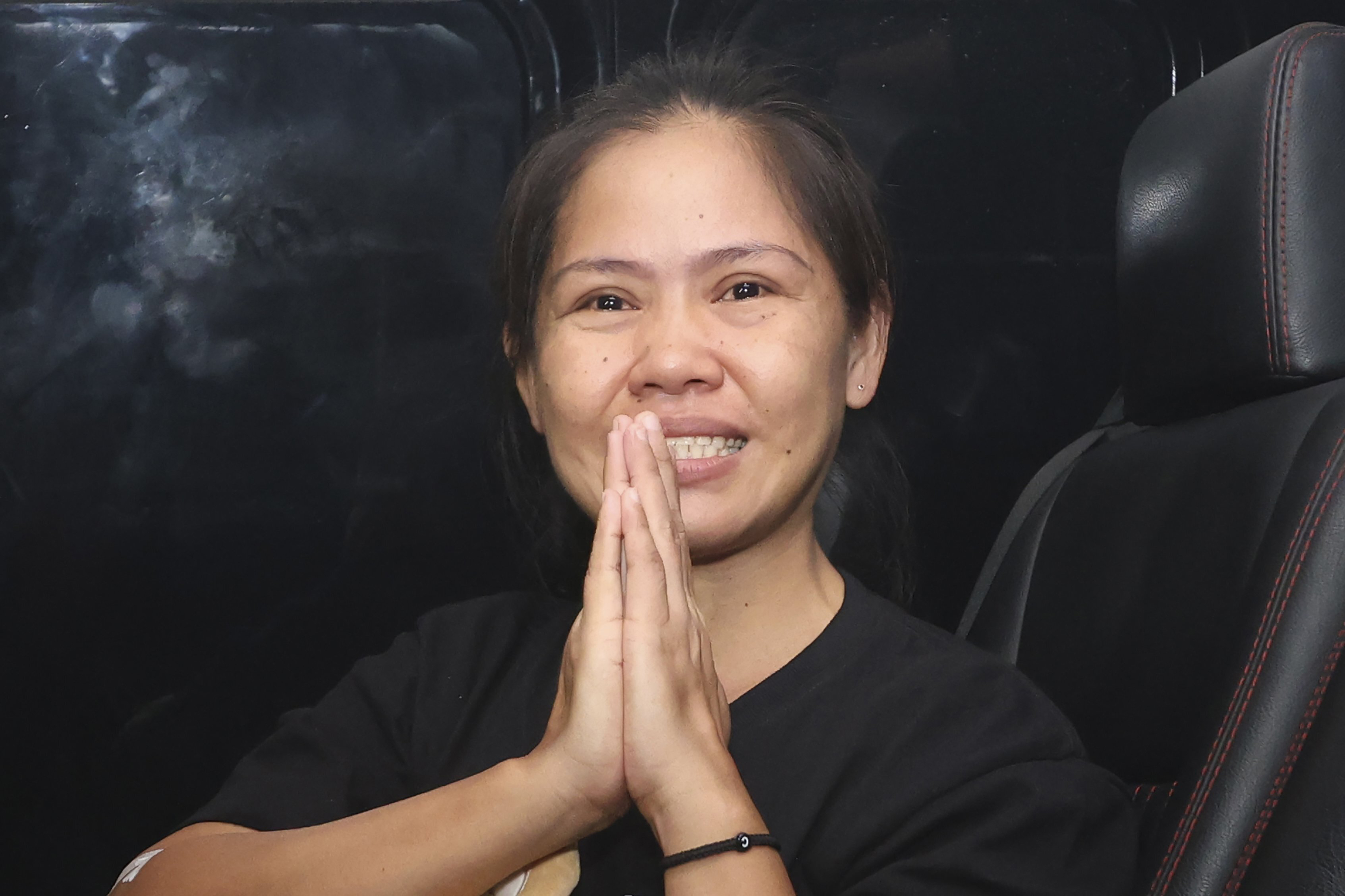 Filipino death row inmate Mary Jane Veloso gestures as she leaves Yogyakarta Women's Prison for her transfer to the capital city of Jakarta in preparation for her repatriation to the Philippines, in Gunung Kidul, Indonesia, Sunday, Dec. 15, 2024. (AP Photo/Slamet Riyadi)