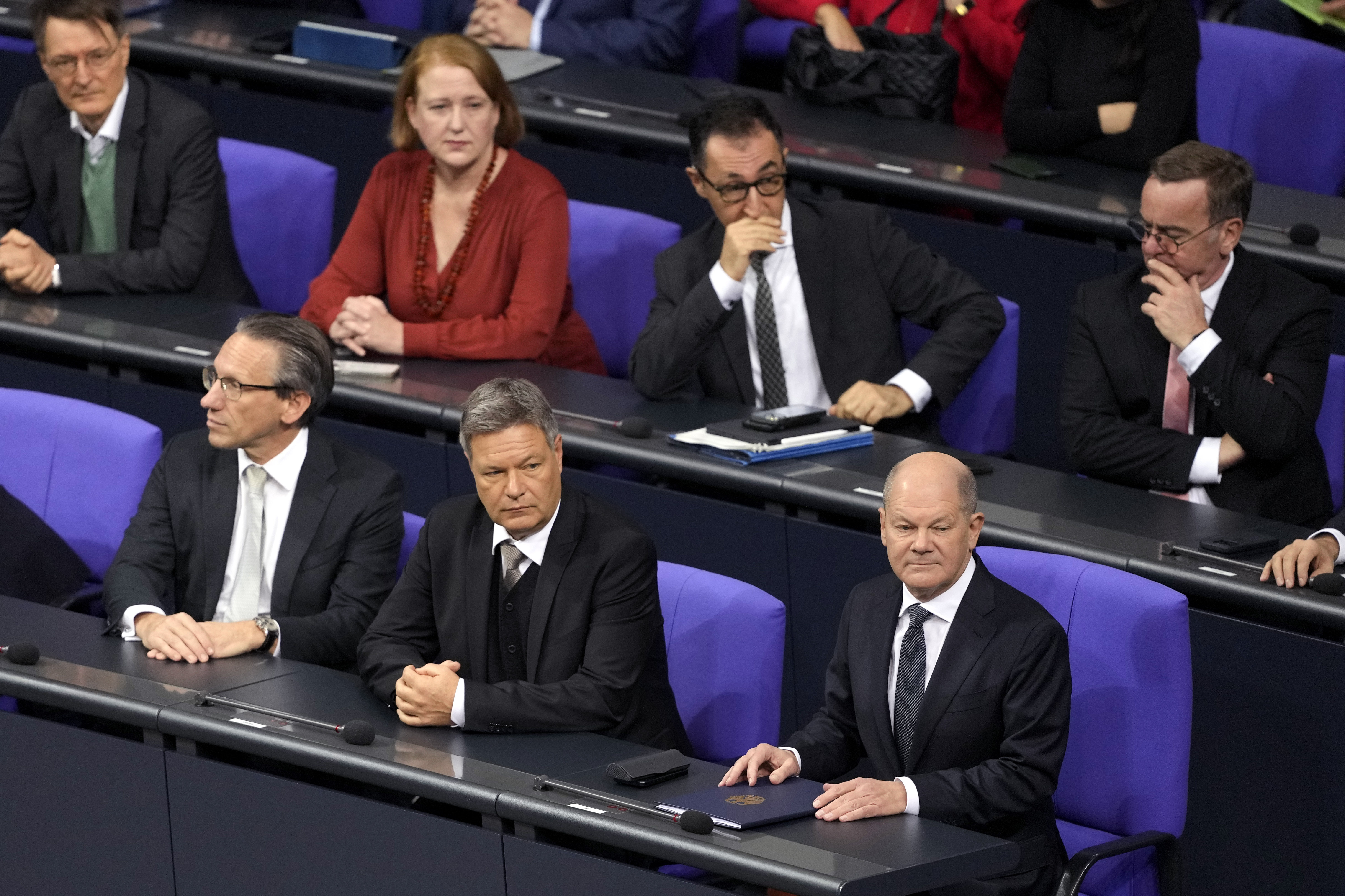 German Chancellor Olaf Scholz,, bottom right, attends a plenary session at the German parliament Bundestag where he faces a vote of confidence, Berlin, Germany, Monday, Dec. 16, 2024. (AP Photo/Markus Schreiber)