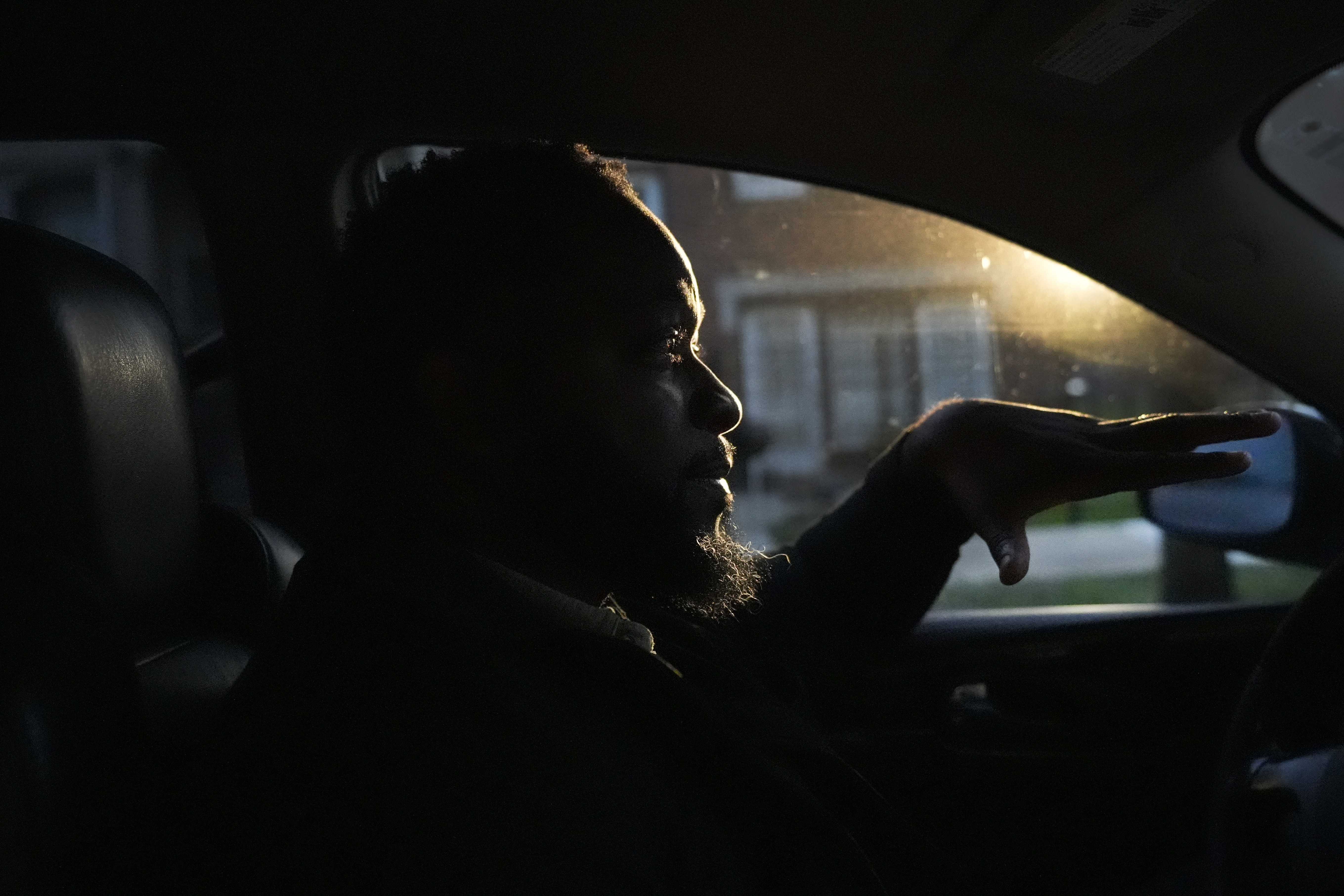 PiggyBack Network, co-founder and CEO Ismael El-Amin talks about the Piggyback ride-share program on Friday, Oct. 18, 2024, while he waits to drop off the last of two children he drove to school as part of the program in Chicago. (AP Photo/Charles Rex Arbogast)