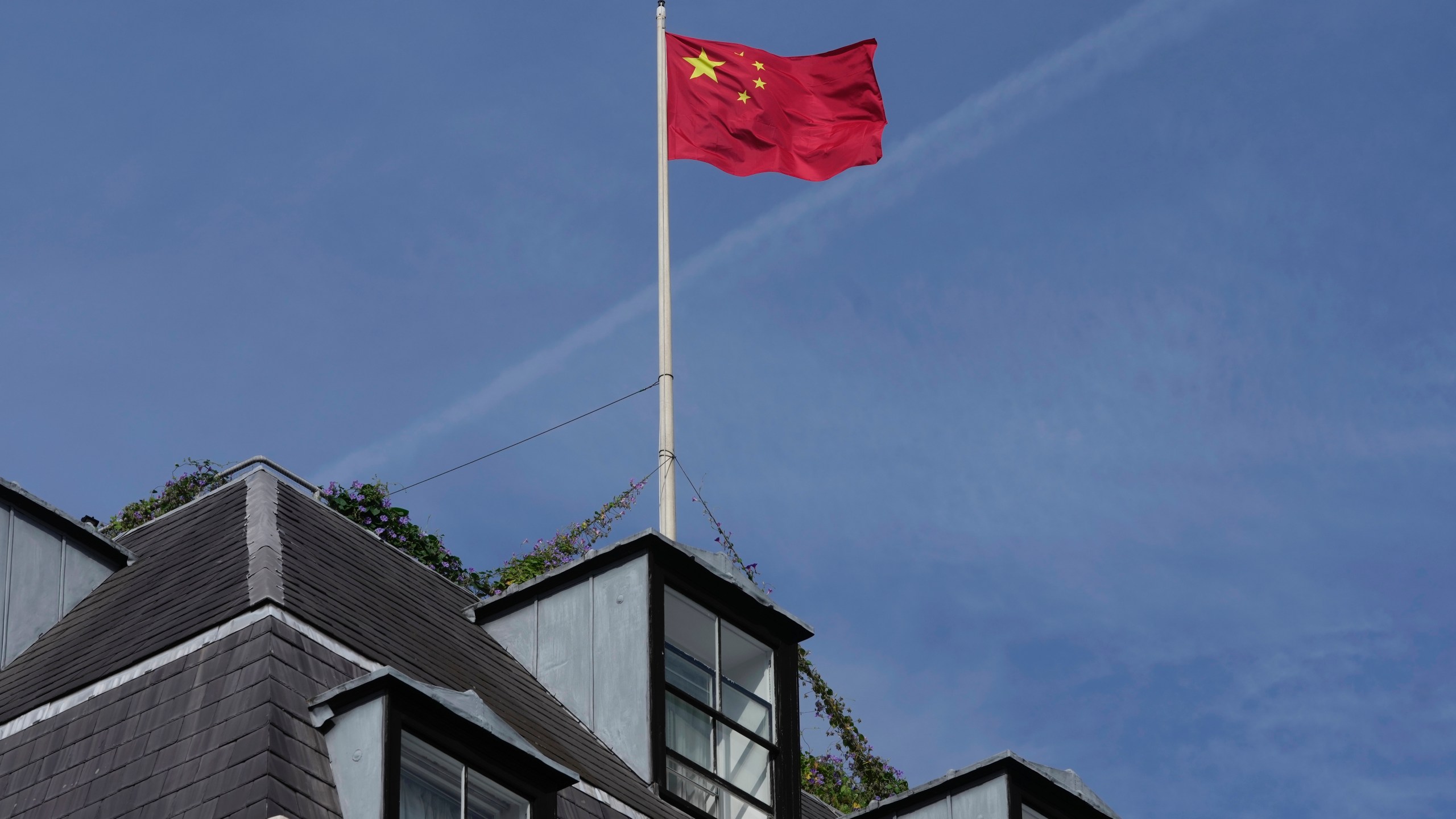 FILE - A Chinese national flag is raised at the Chinese embassy in London, Monday, Sept. 11, 2023. (AP Photo/Kin Cheung, File)