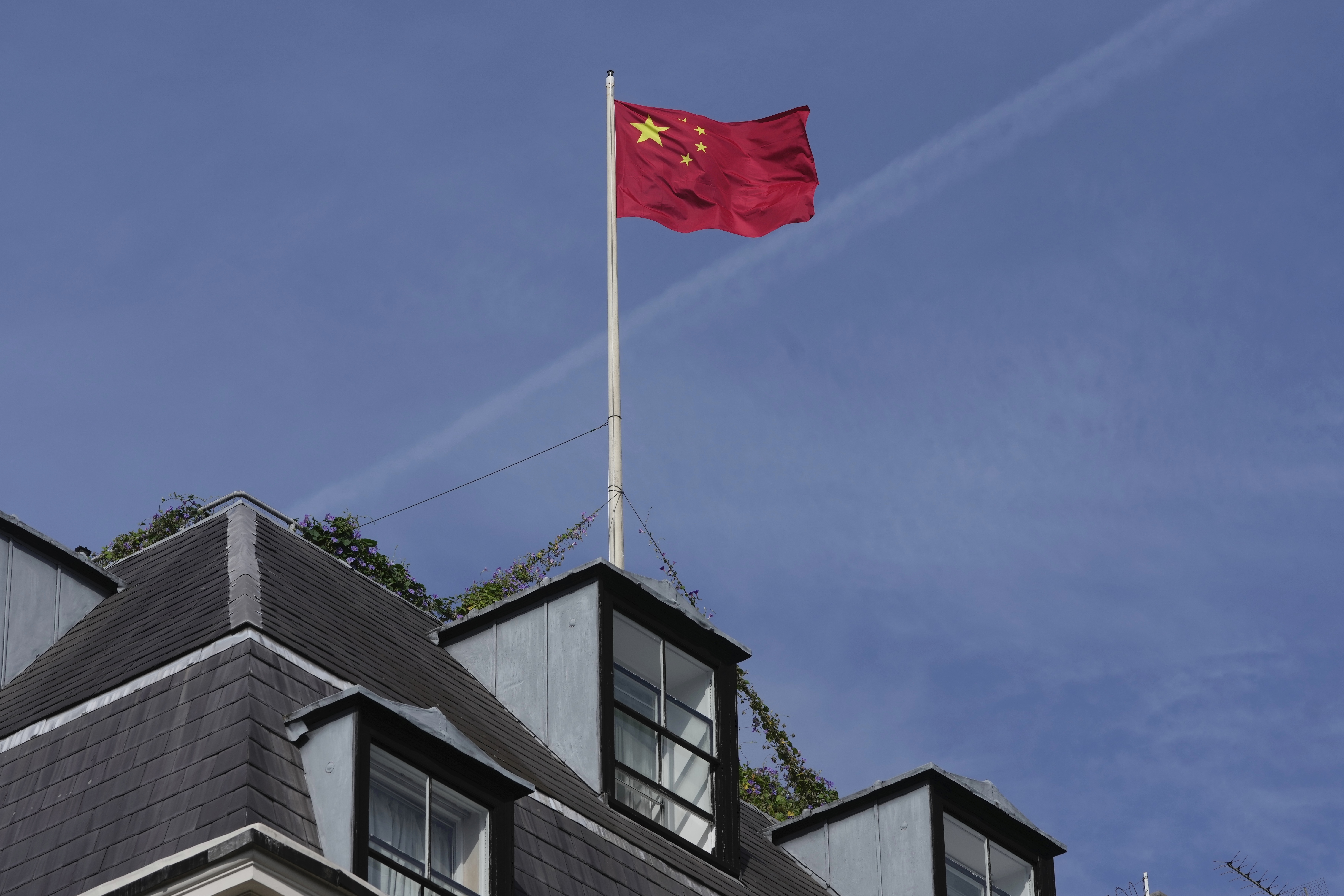 FILE - A Chinese national flag is raised at the Chinese embassy in London, Monday, Sept. 11, 2023. (AP Photo/Kin Cheung, File)