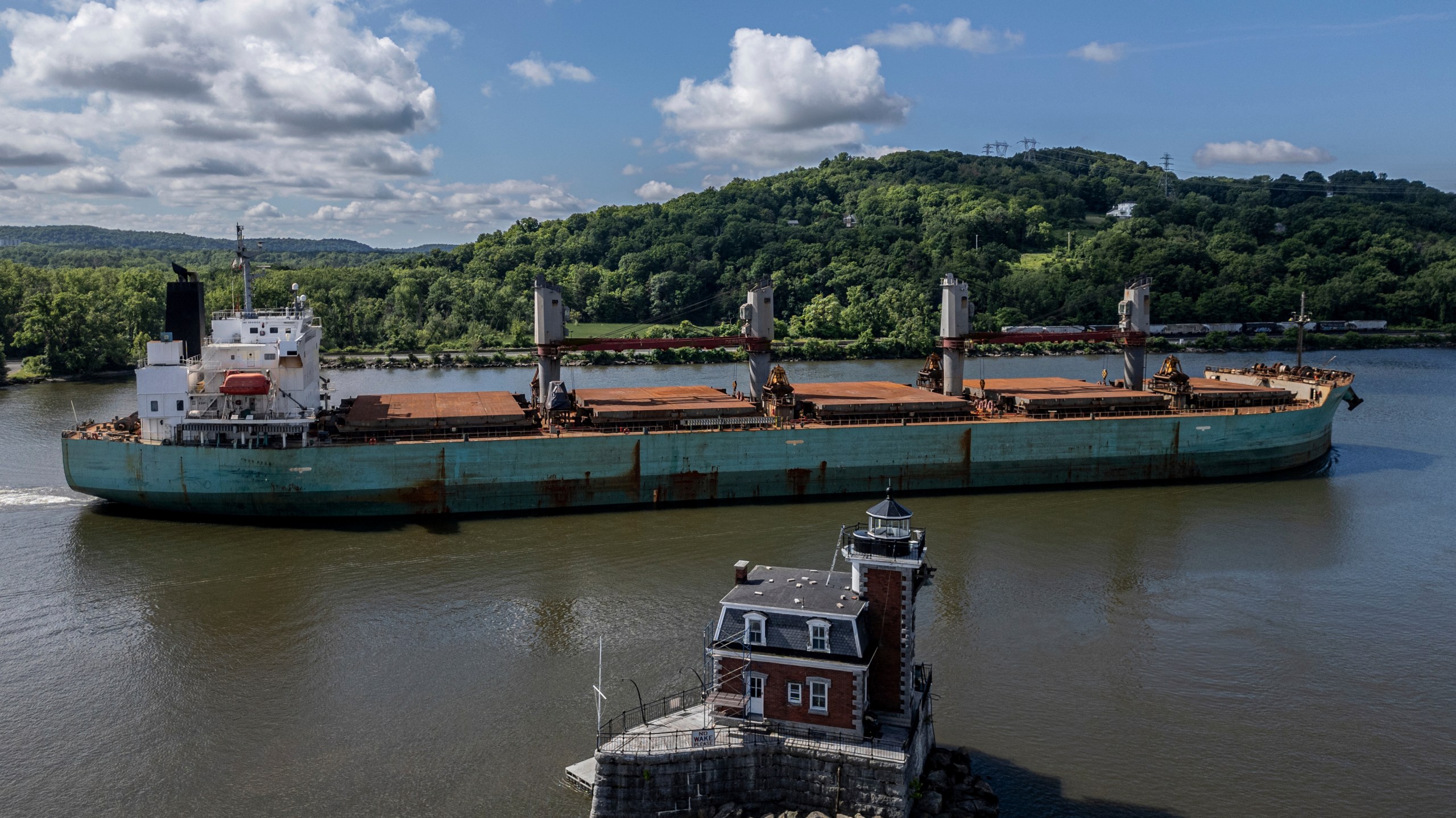 FILE - A ship passes by the Hudson-Athens Lighthouse, Wednesday, June 12, 2024, in Hudson, N.Y. (AP Photo/Julia Nikhinson, File)