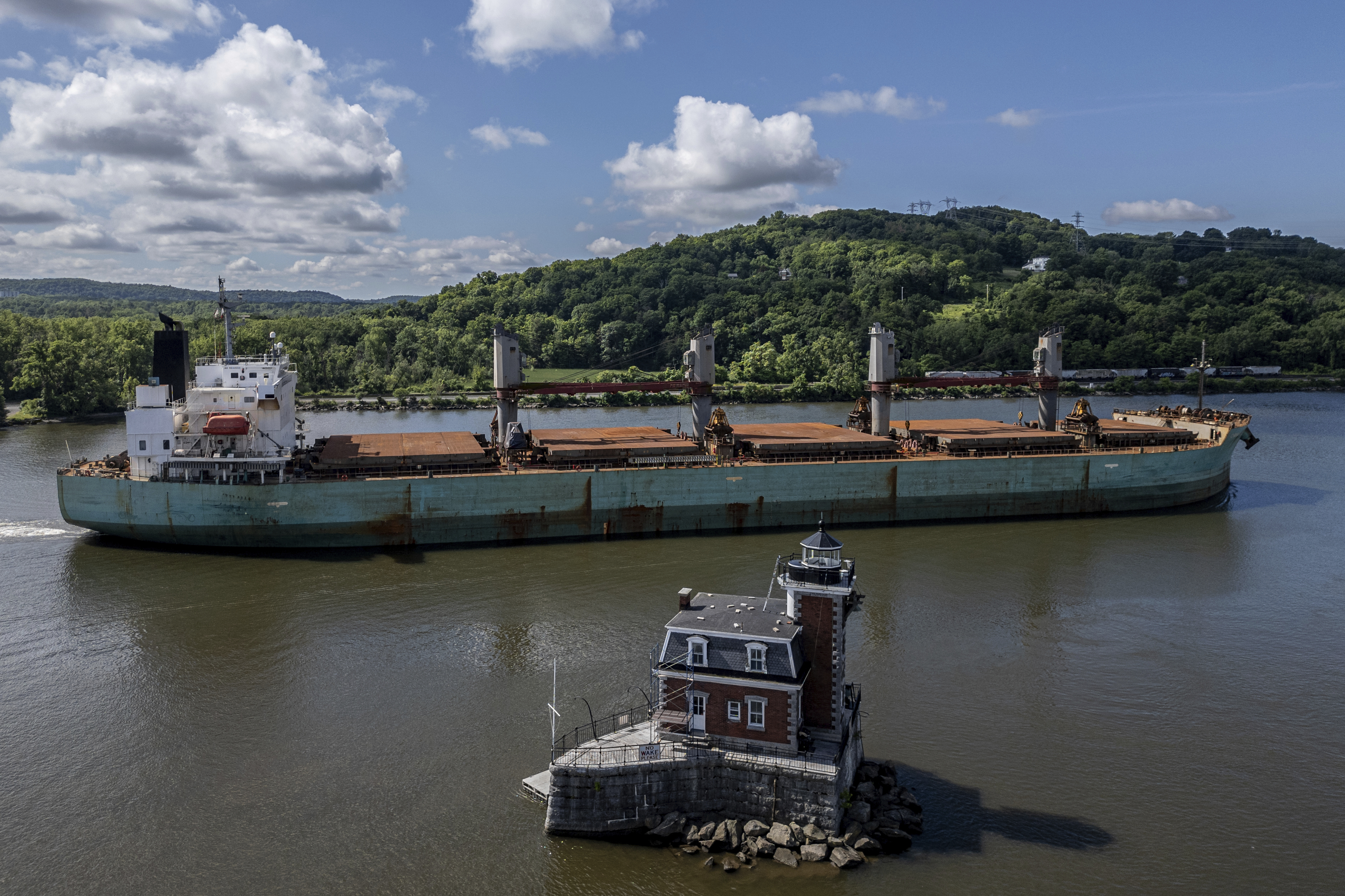 FILE - A ship passes by the Hudson-Athens Lighthouse, Wednesday, June 12, 2024, in Hudson, N.Y. (AP Photo/Julia Nikhinson, File)