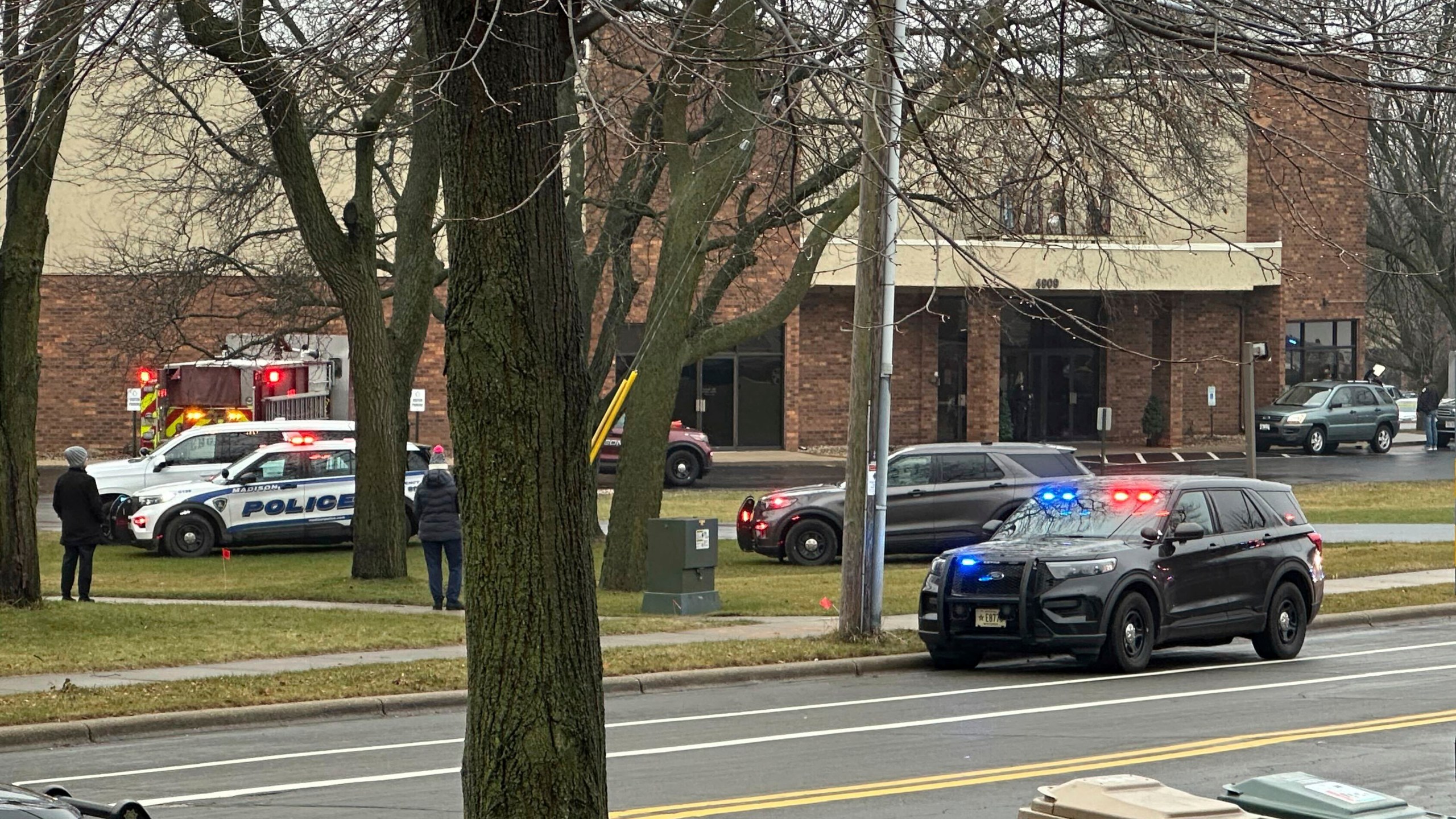 Emergency vehicles are parked outside the Abundant Life Christian School in Madison, Wis., where multiple injuries were reported following a shooting, Monday, Dec. 16, 2024. (AP Photo/Scott Bauer)