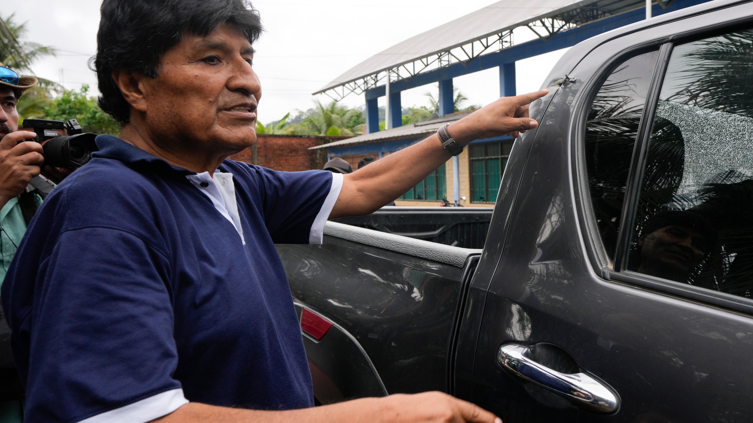 FILE - Former Bolivia's President Evo Morales points to a bullet hole on his car that he claims was the result of an assassination attempt, in Lauca N, Chapare region, Bolivia, Nov. 3, 2024, amid an ongoing political conflict with the government of President Luis Arce. (AP Photo/Juan Karita, File)