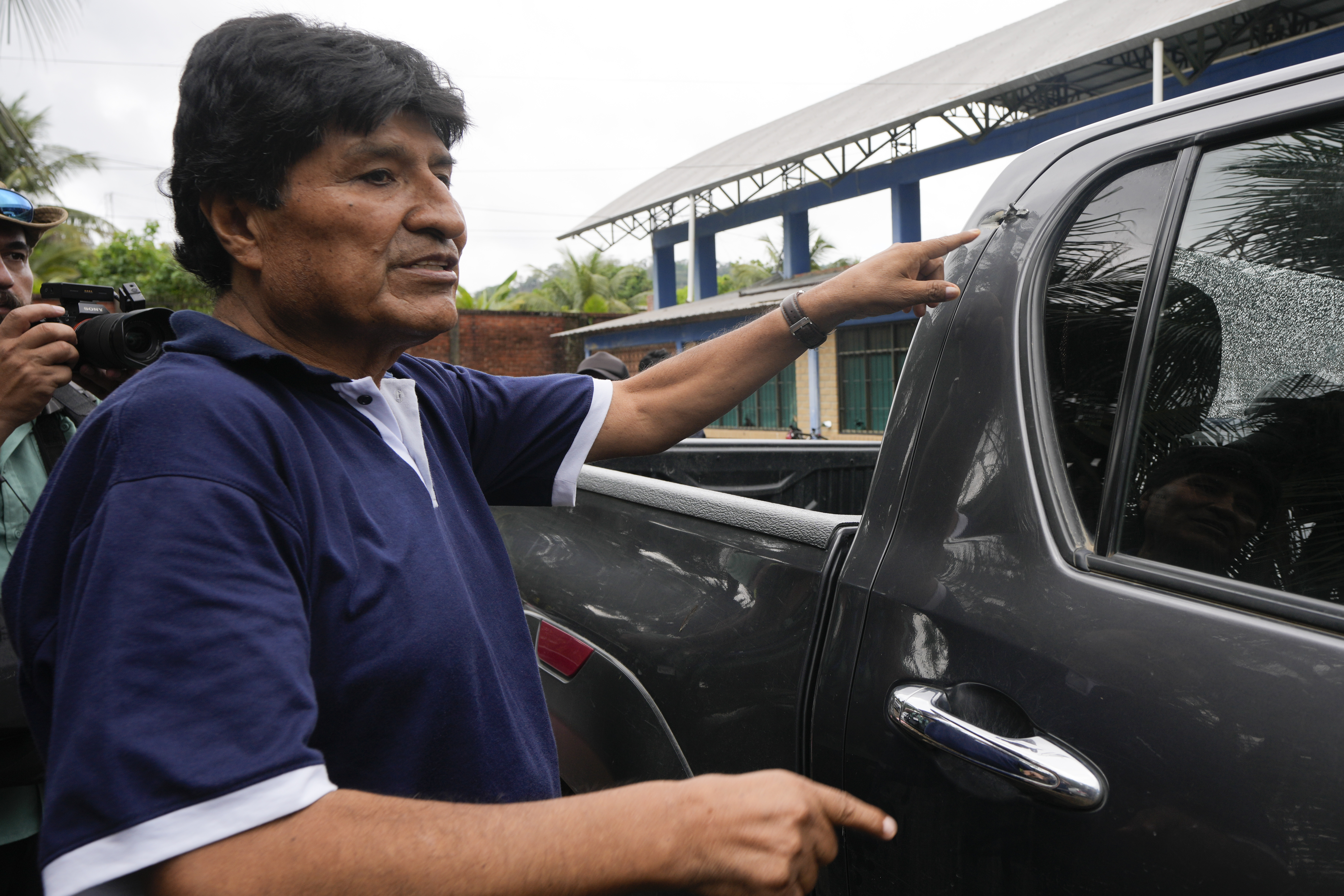 FILE - Former Bolivia's President Evo Morales points to a bullet hole on his car that he claims was the result of an assassination attempt, in Lauca N, Chapare region, Bolivia, Nov. 3, 2024, amid an ongoing political conflict with the government of President Luis Arce. (AP Photo/Juan Karita, File)